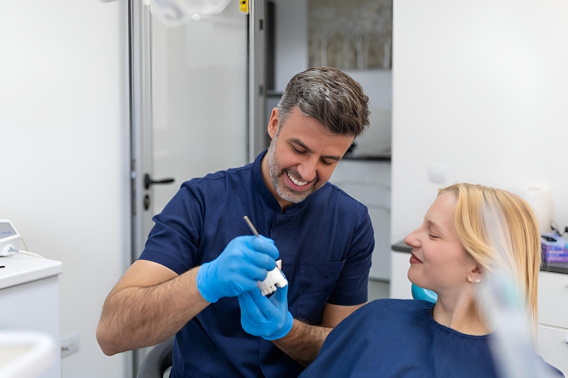 A Dentist is Examining a Woman 's Teeth in a Dental Office — Trower Dental In Casuarina, NT