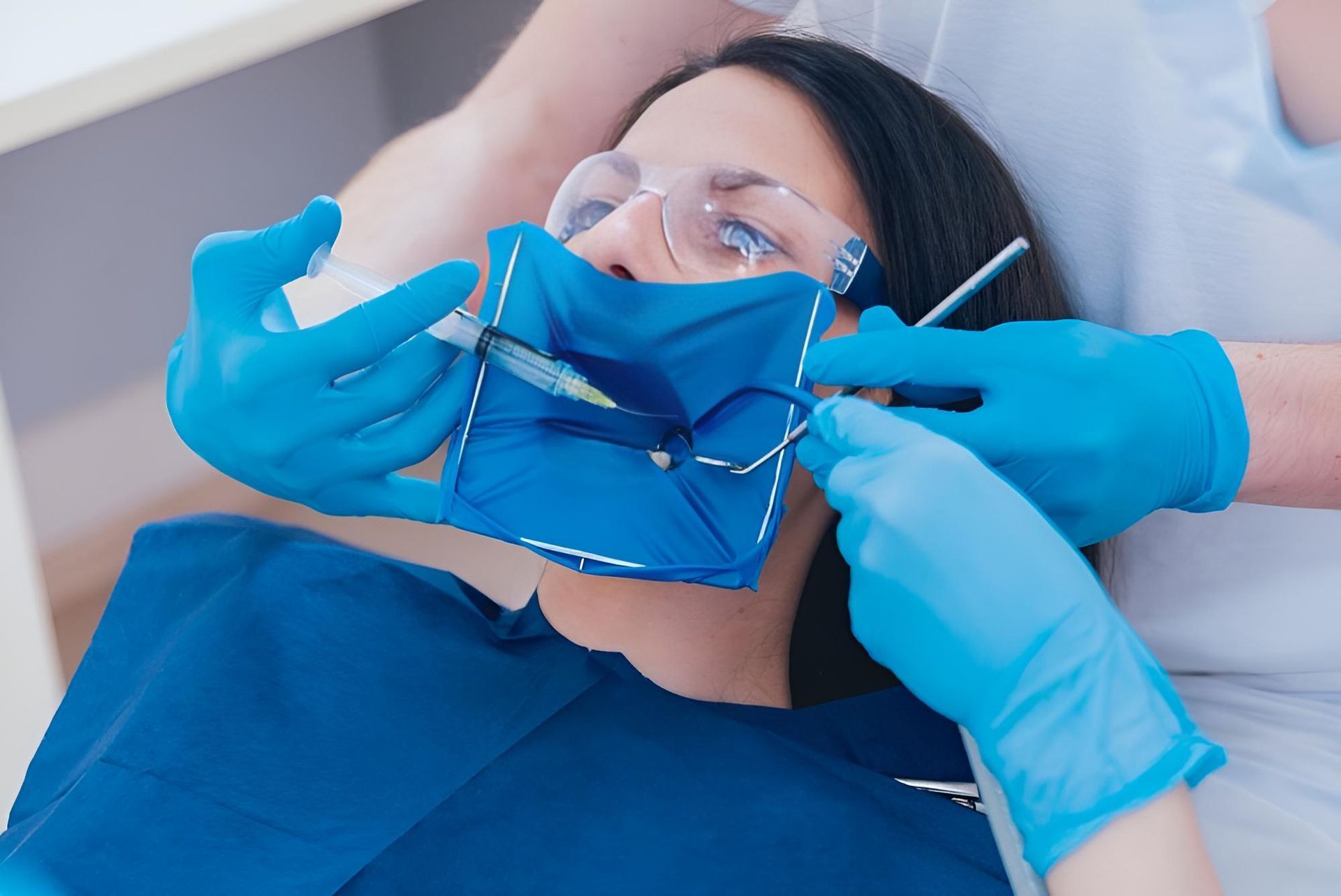 A Woman is Getting Her Teeth Examined by a Dentist — Trower Dental In Casuarina, NT