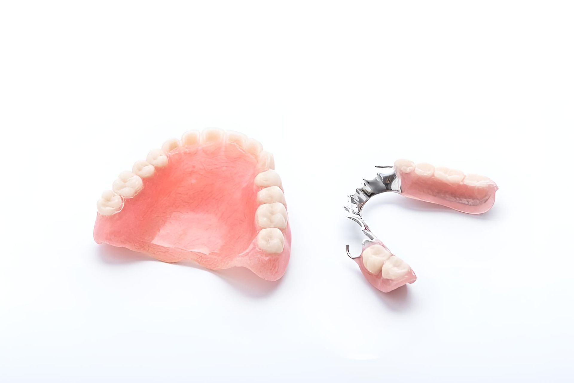 A Denture and a Partial Denture on a White Background — Trower Dental In Darwin, NT