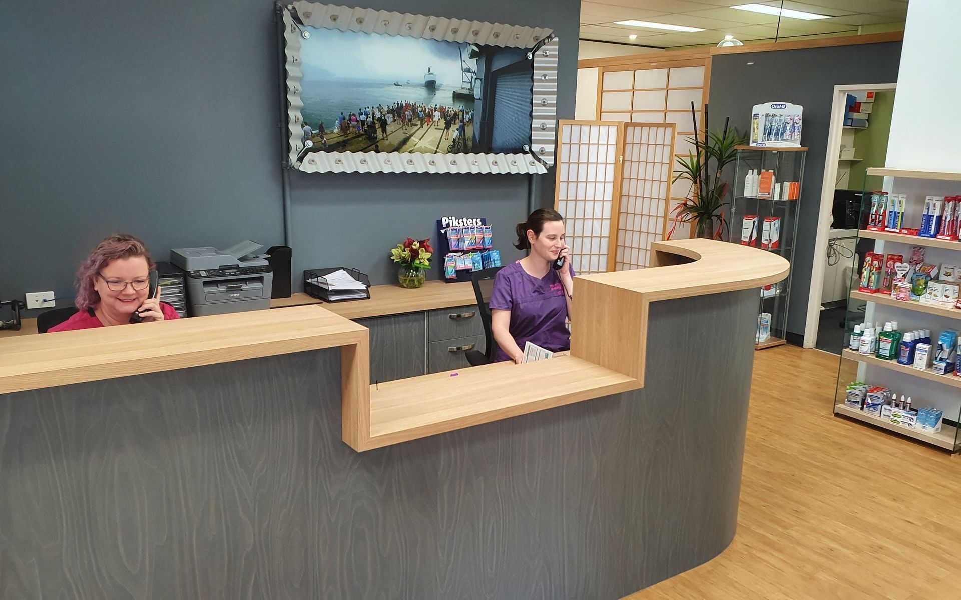 Two Women at a Modern Reception Desk in an Office Setting — Trower Dental In Casuarina, NT