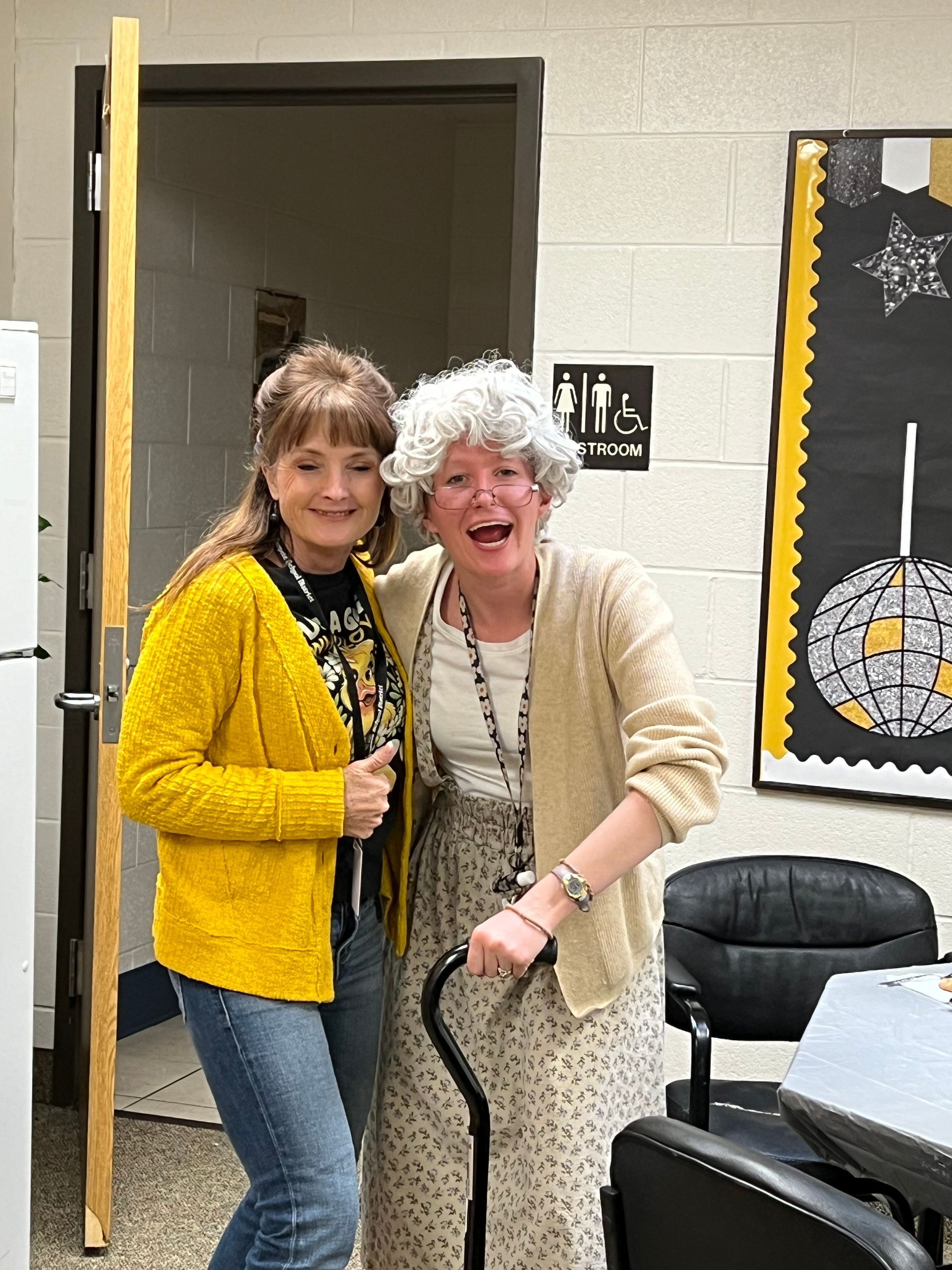 Two women are standing next to each other in a room.