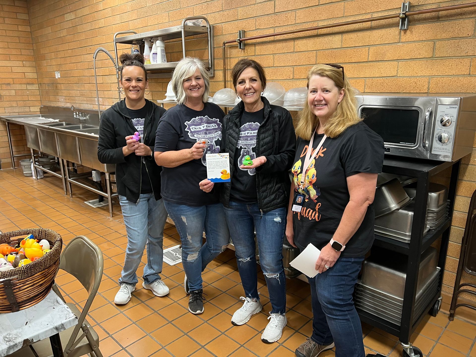 A group of women are posing for a picture in a kitchen.