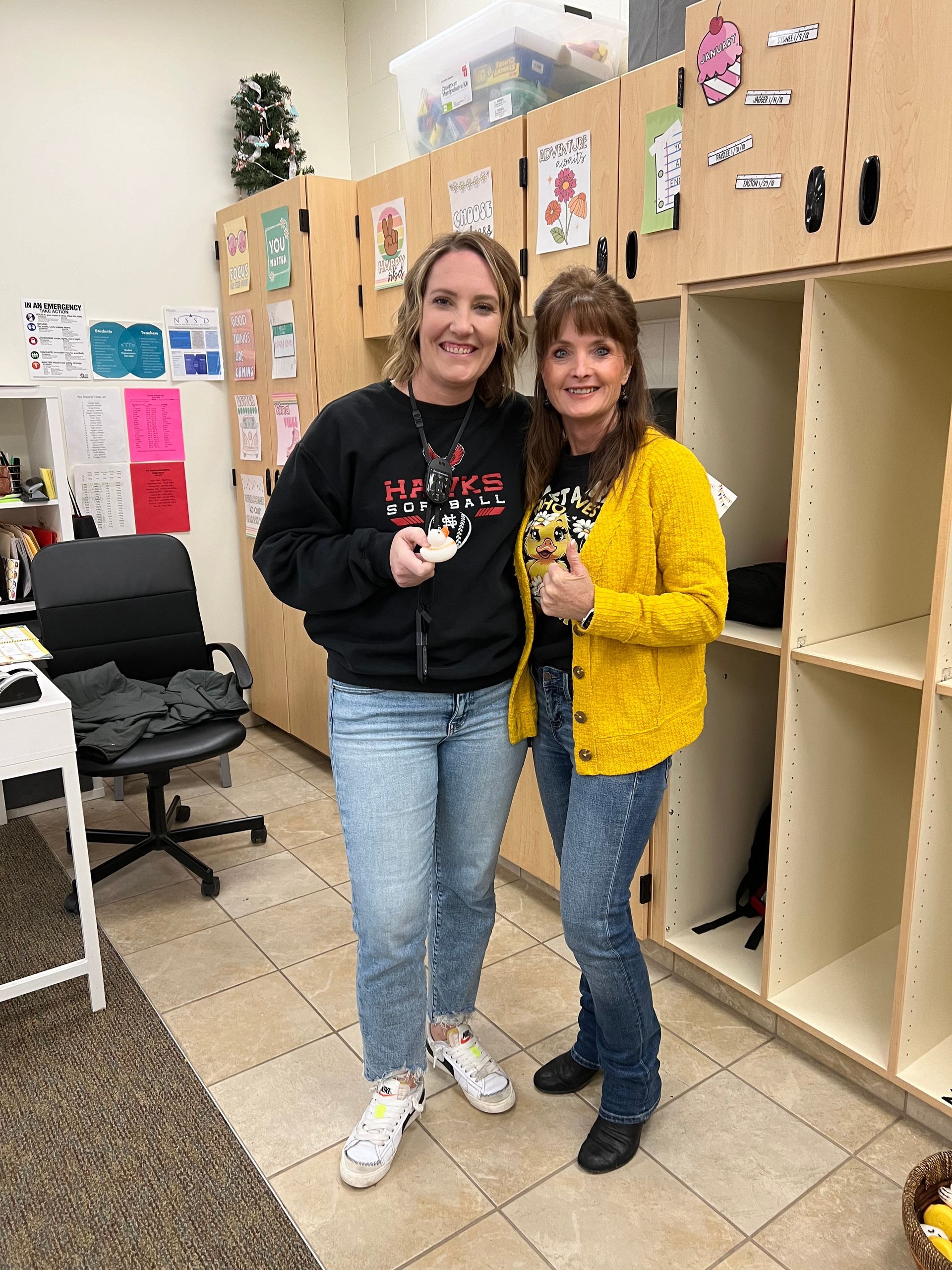 Two women are standing next to each other in a room.