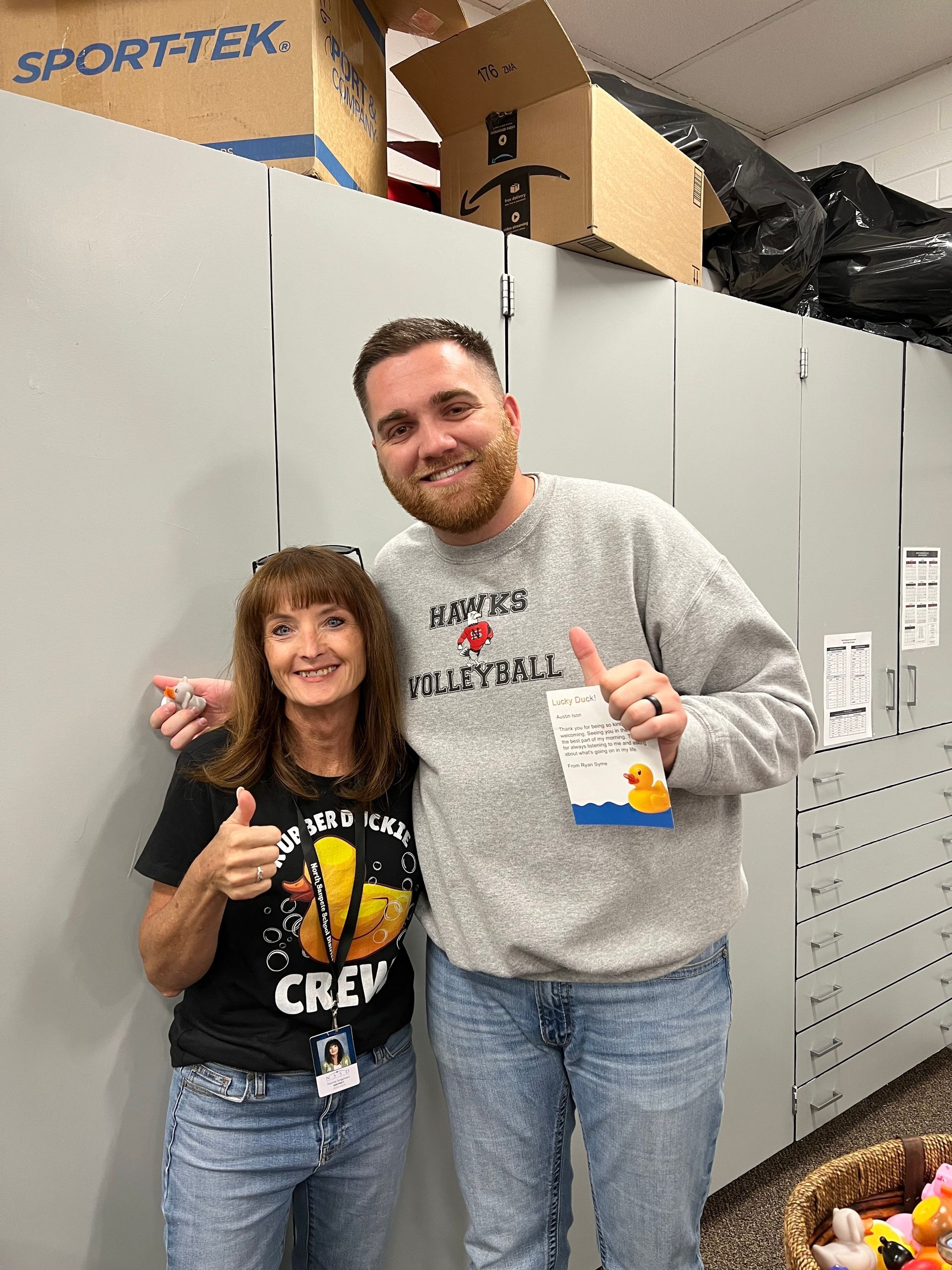 A man and a woman are posing for a picture in a locker room.