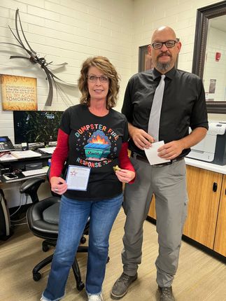 Two people in an office. Woman wears a 