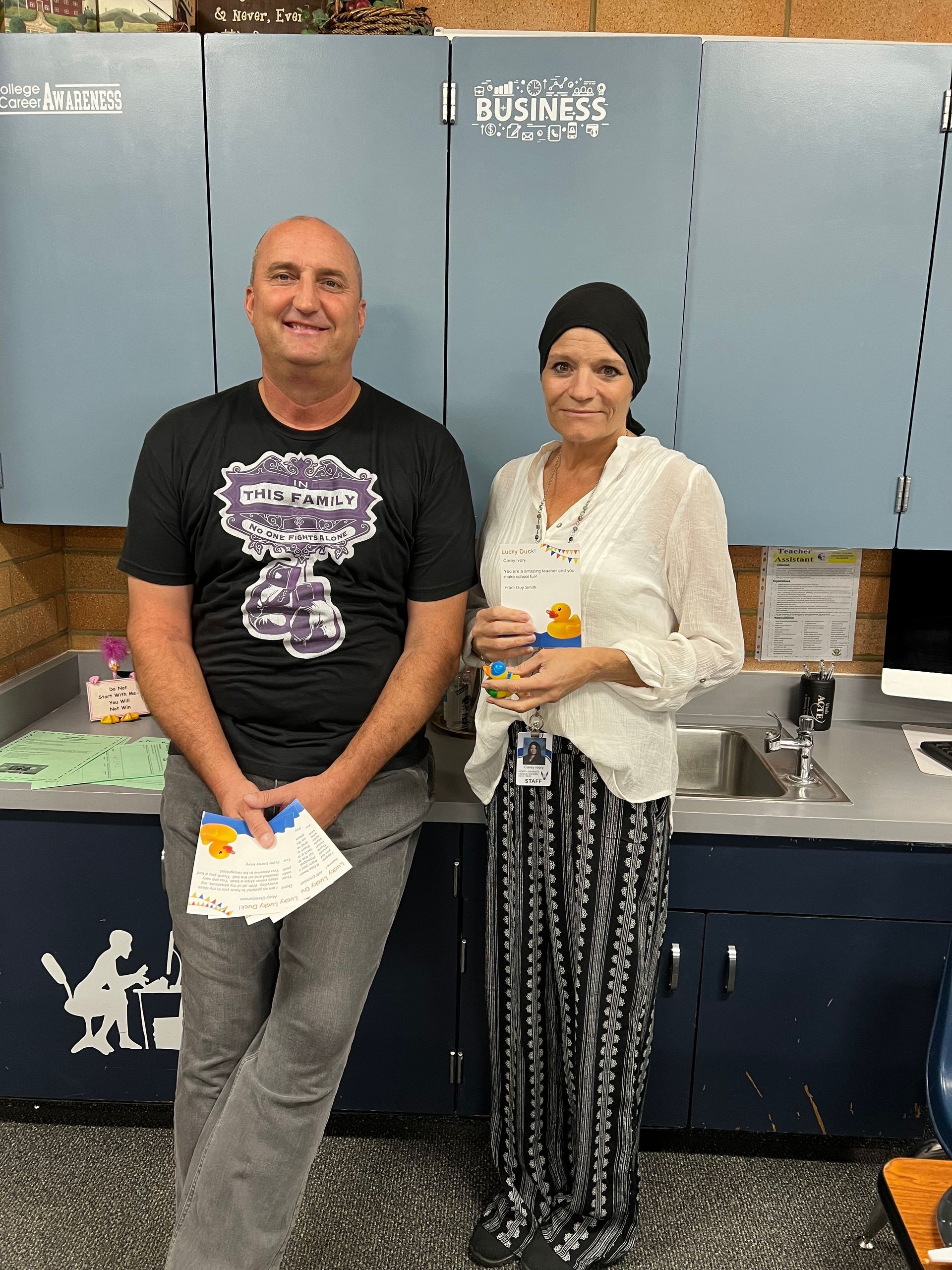 A man and a woman are standing next to each other in a kitchen.