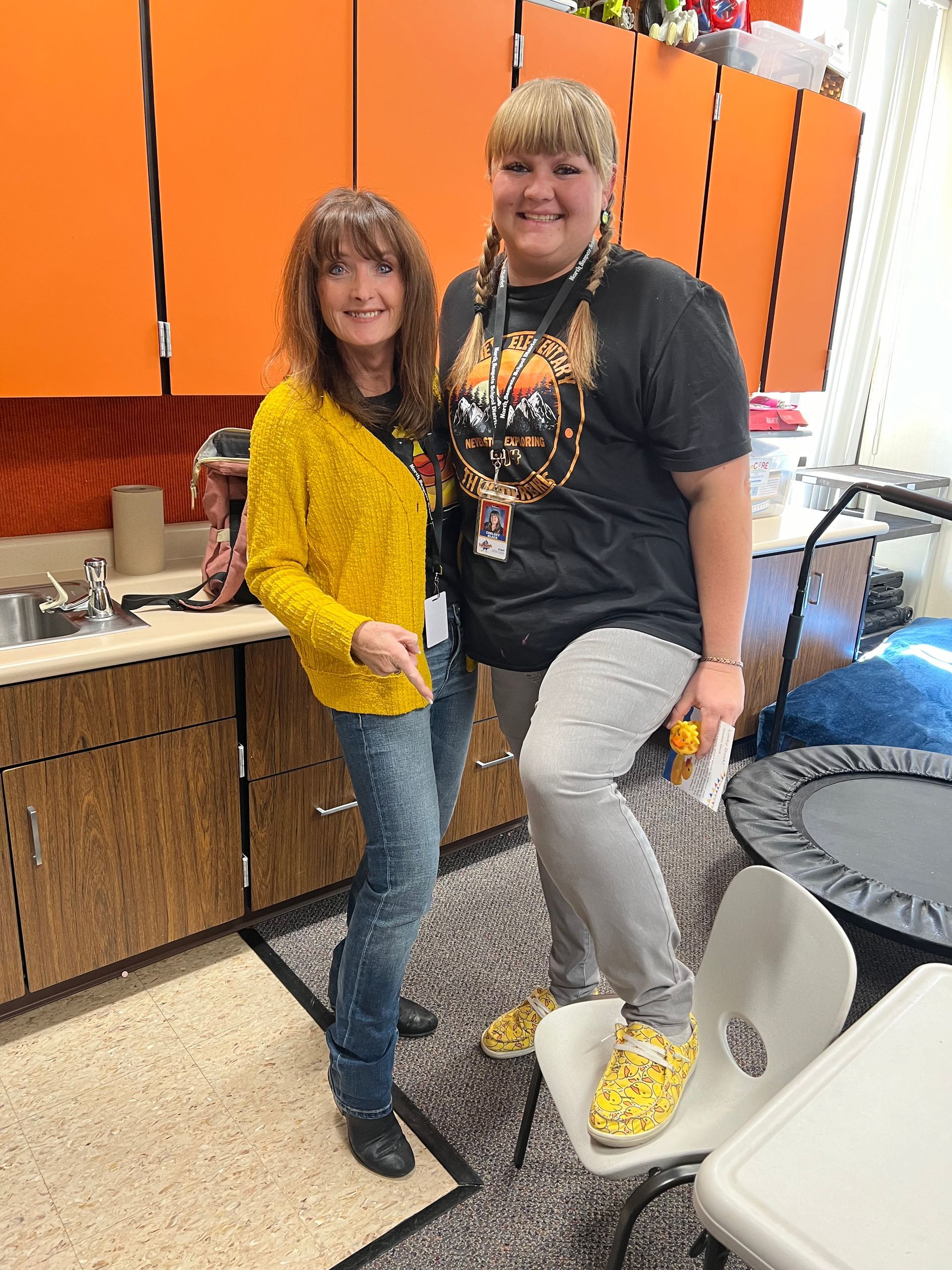 Two women are standing next to each other in a kitchen.