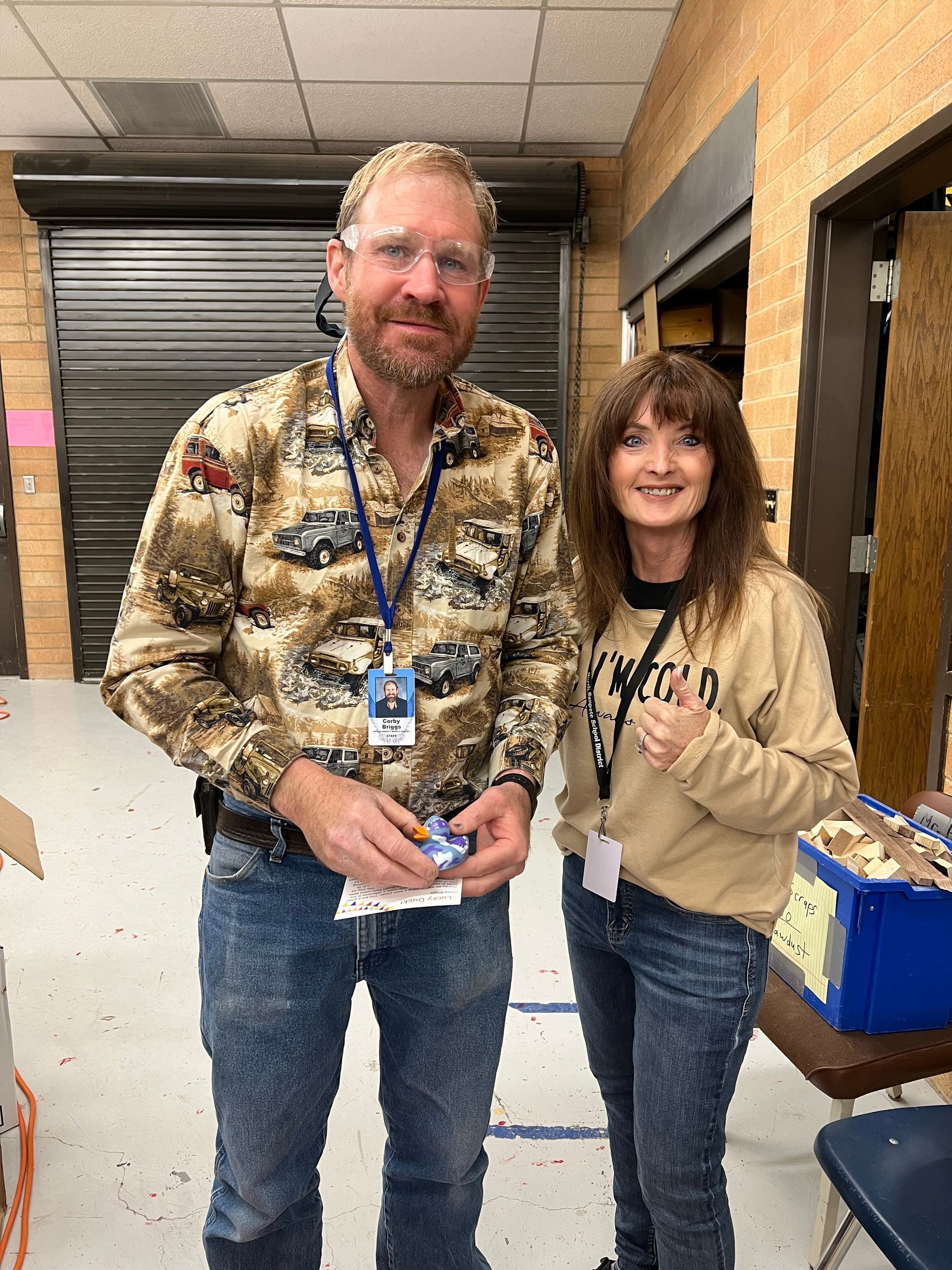 A man and a woman are standing next to each other in a room.