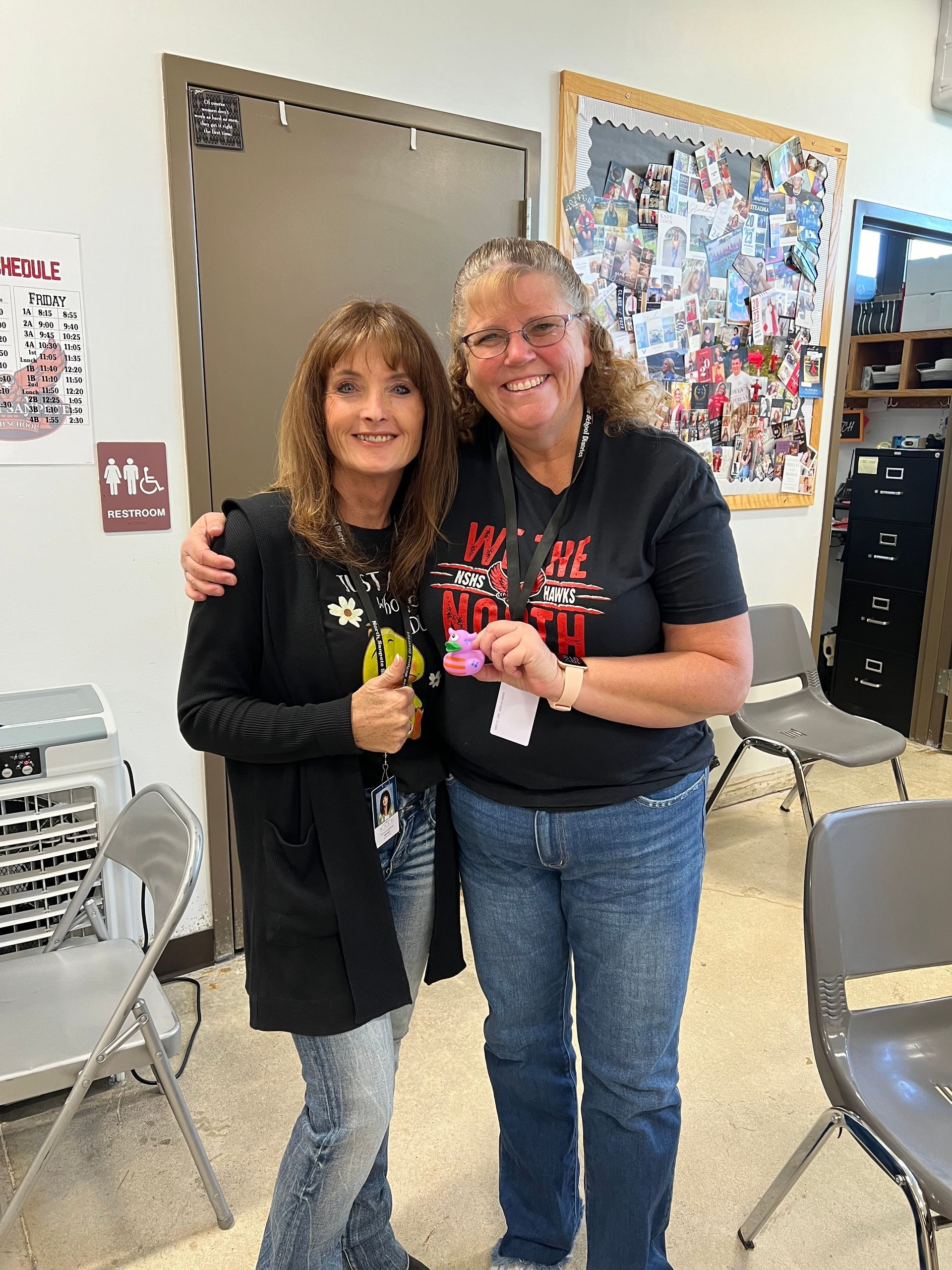 Two women are standing next to each other in a room.