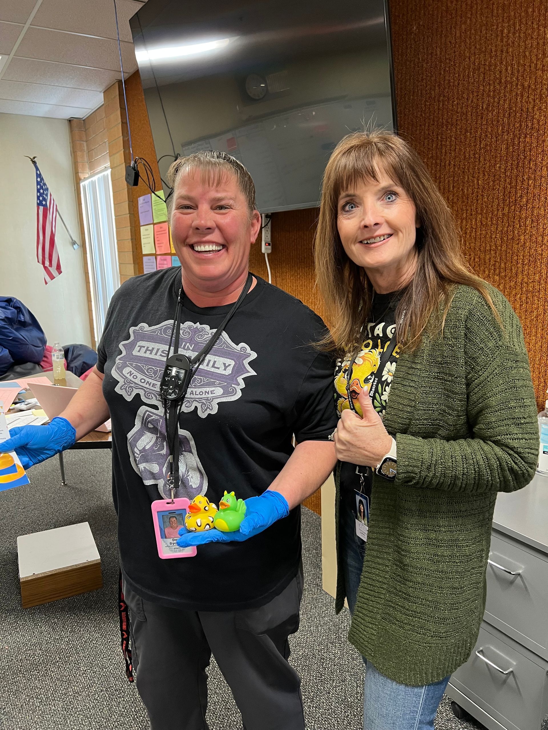 A man and a woman are holding rubber ducks in their hands.