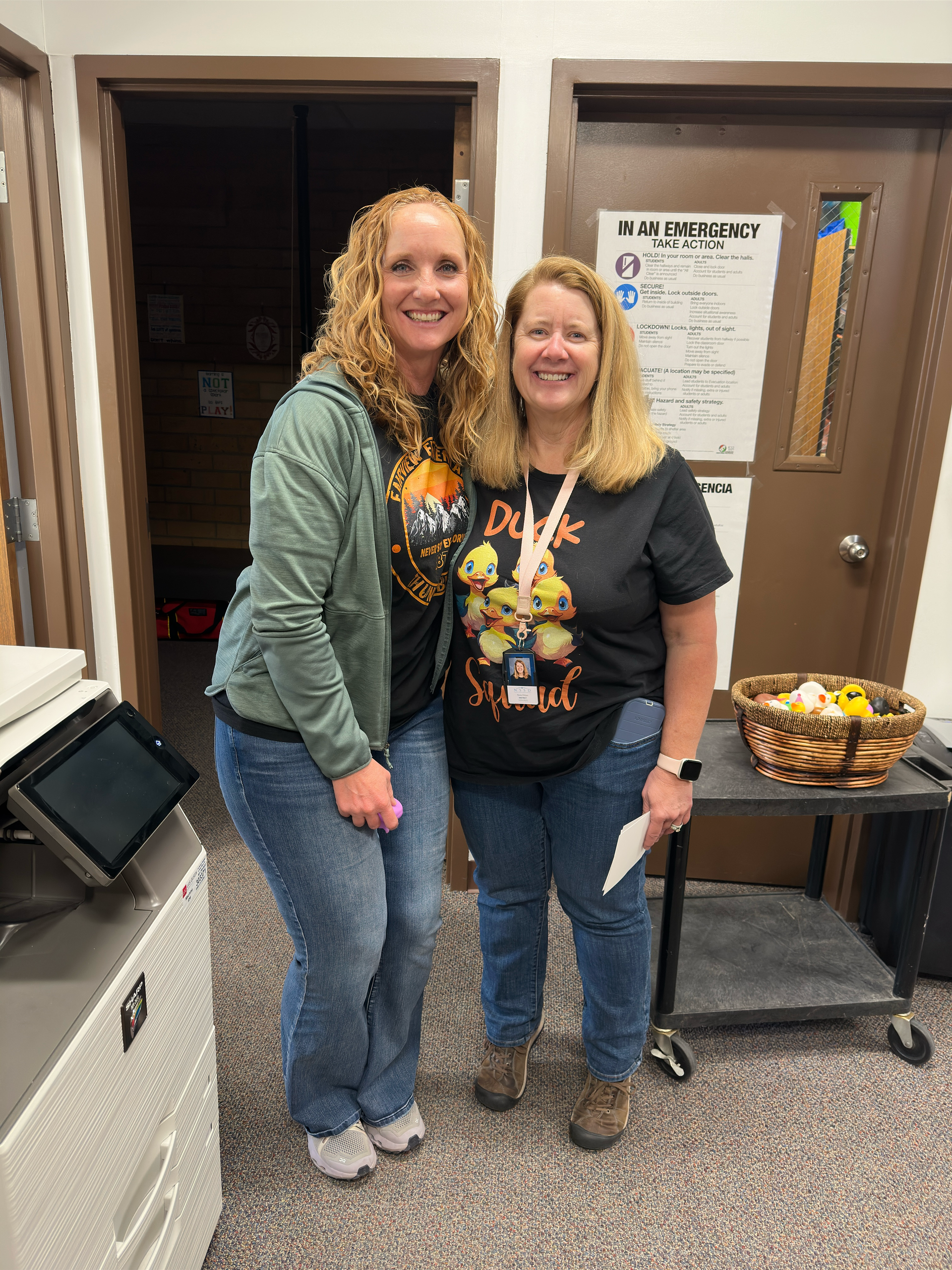 Two women are standing next to each other in a room.