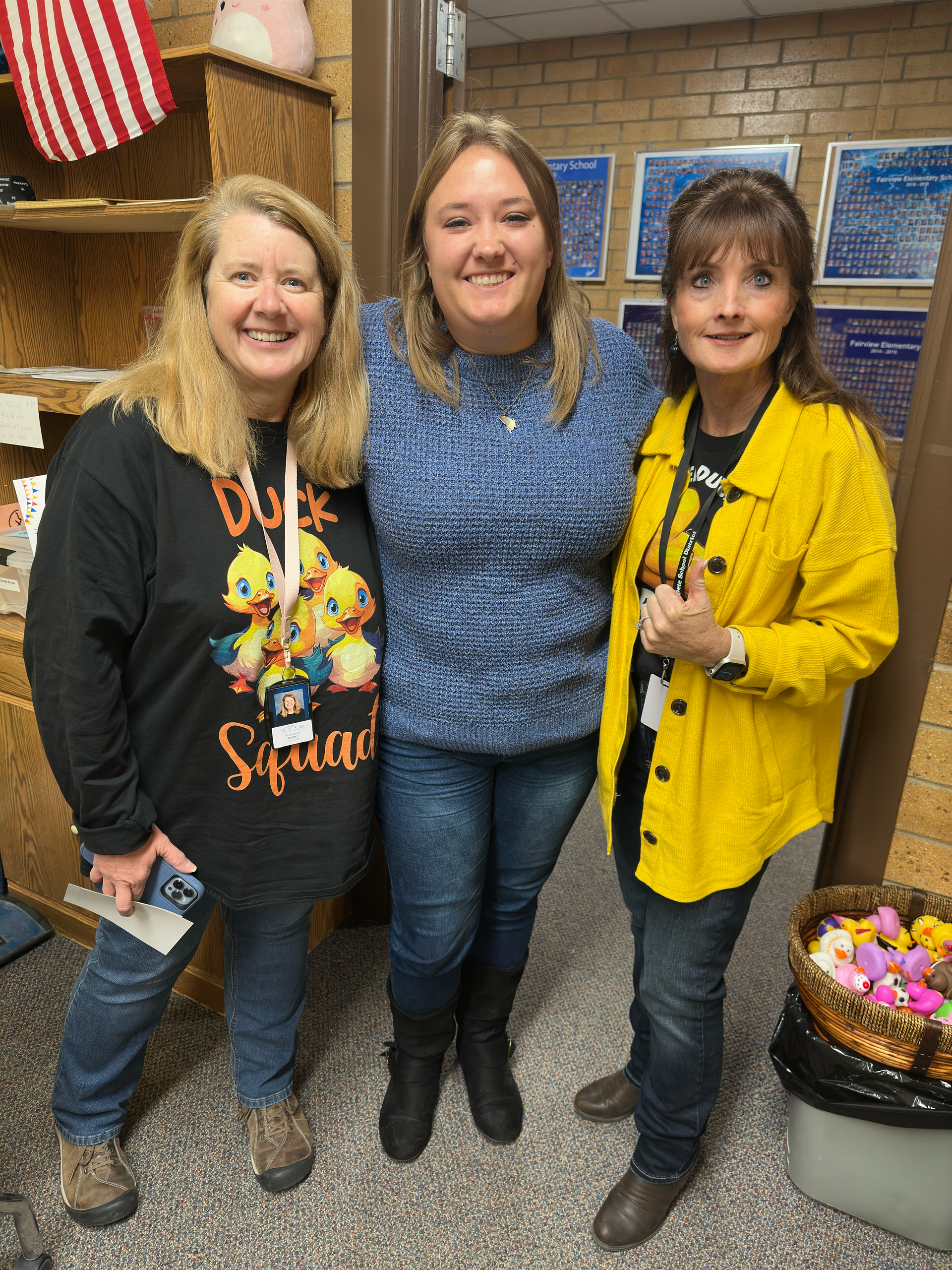 Three women are posing for a picture together in a room.