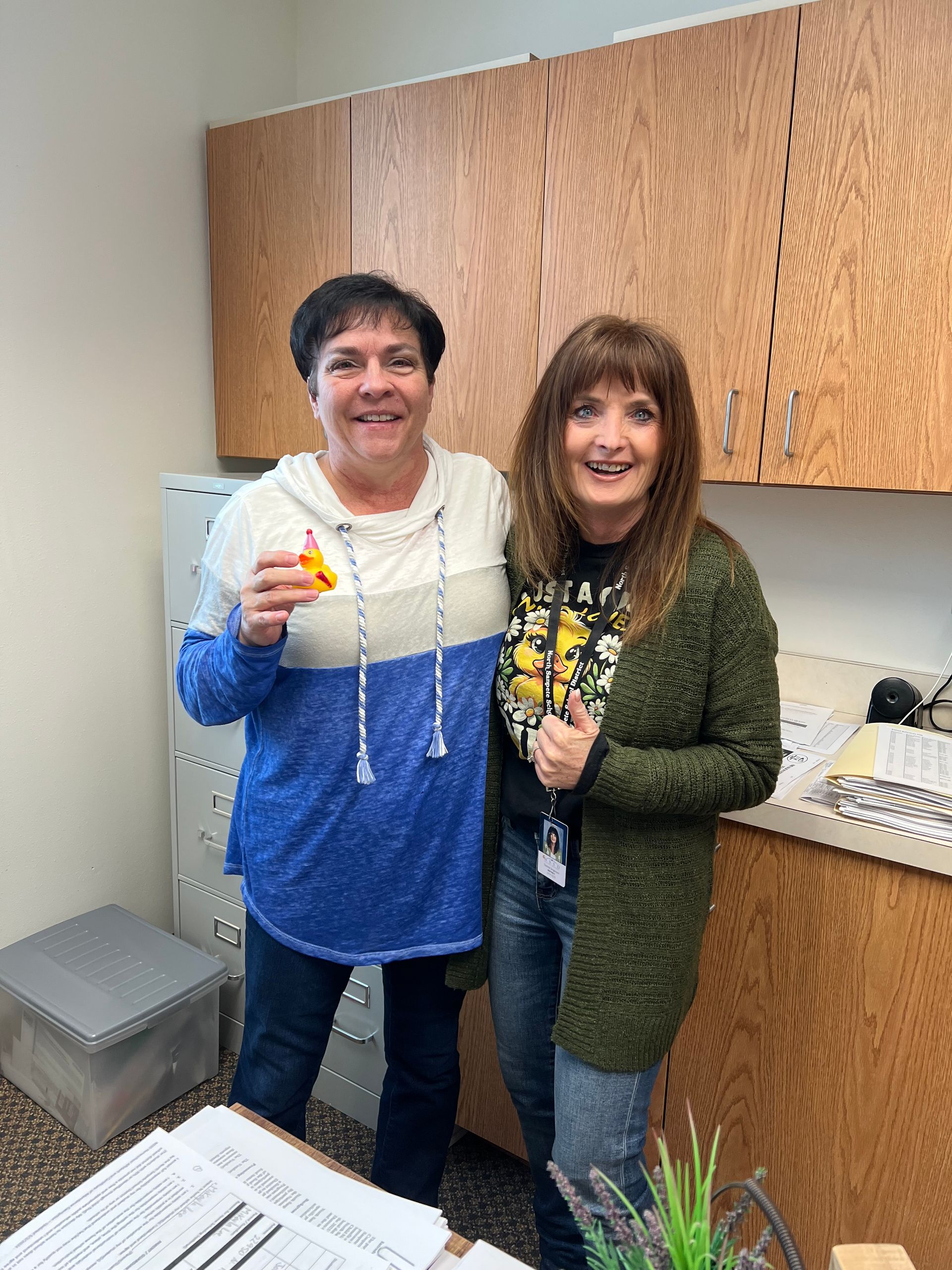 Two women are standing next to each other in a kitchen.