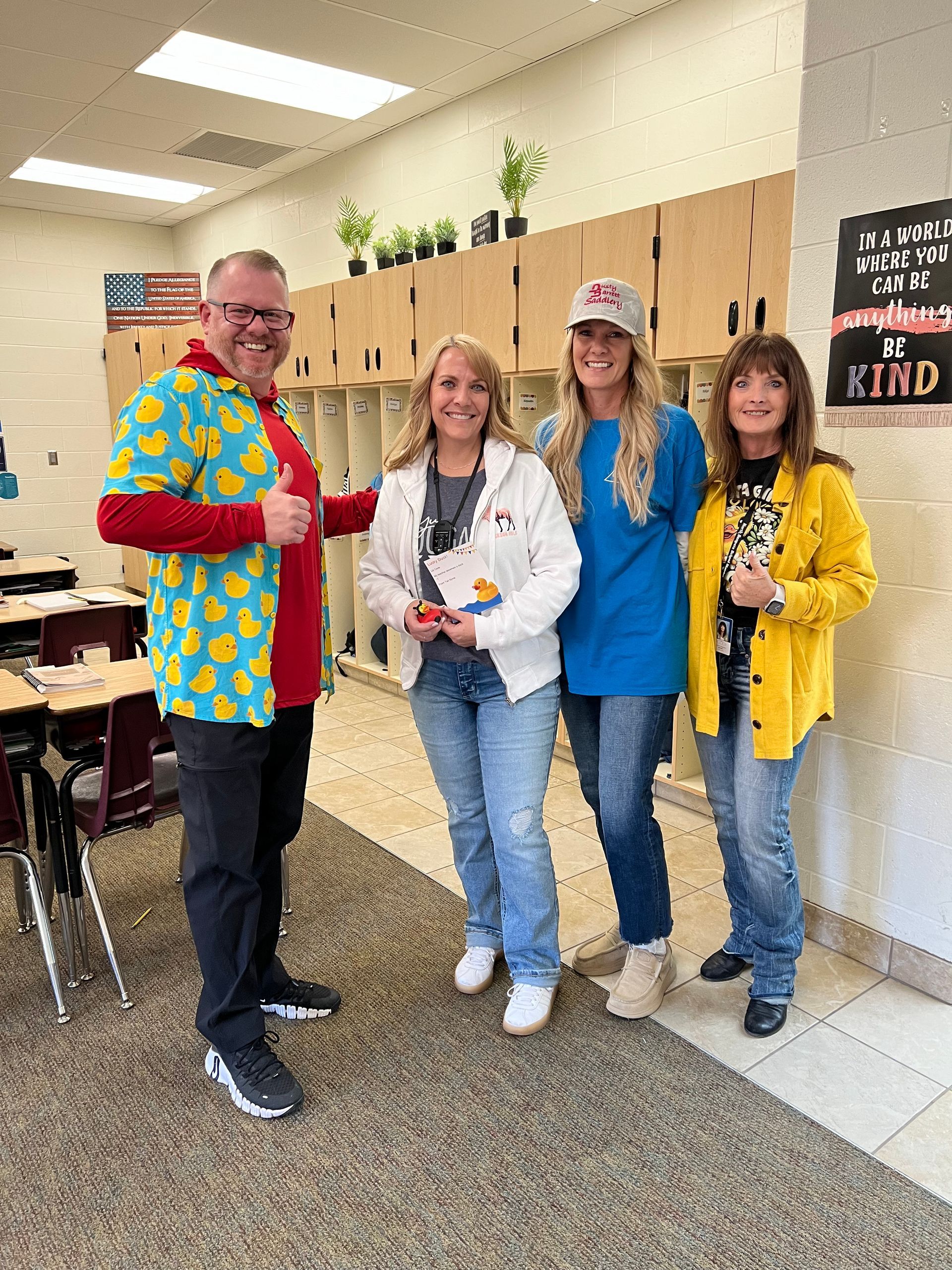 A group of people are standing next to each other in a classroom.