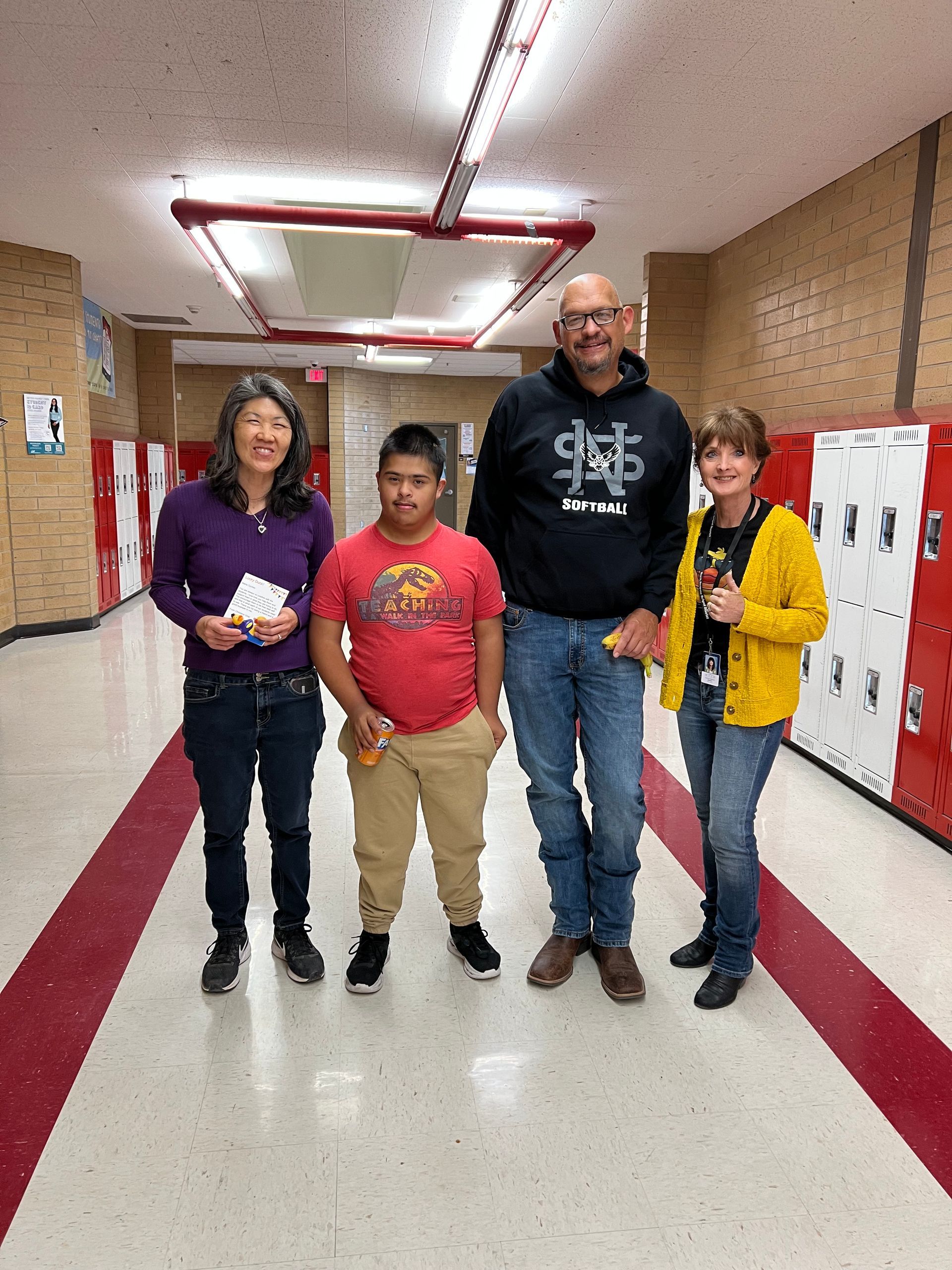 A group of people are standing in a hallway.