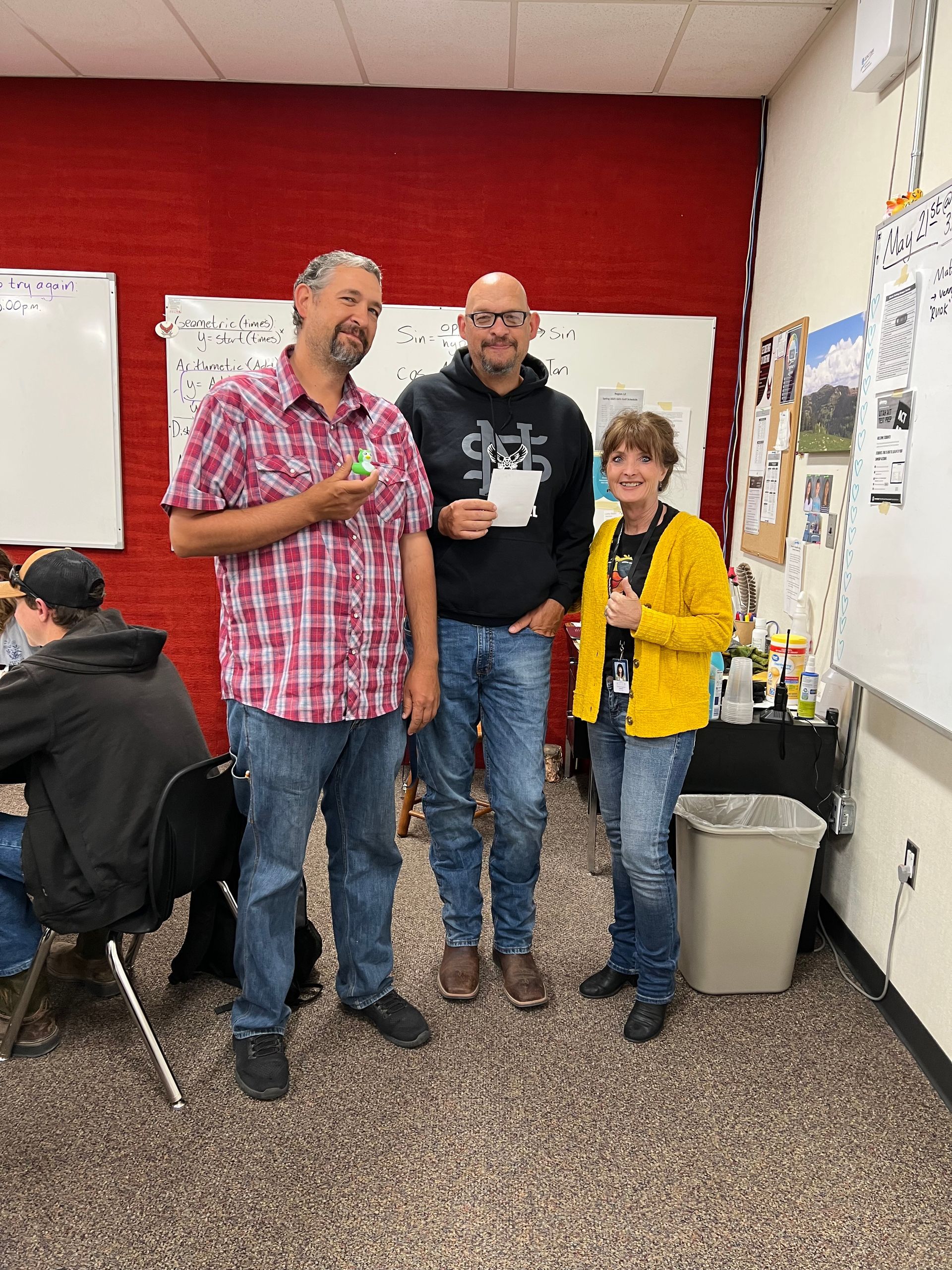 A group of people are standing next to each other in a room.
