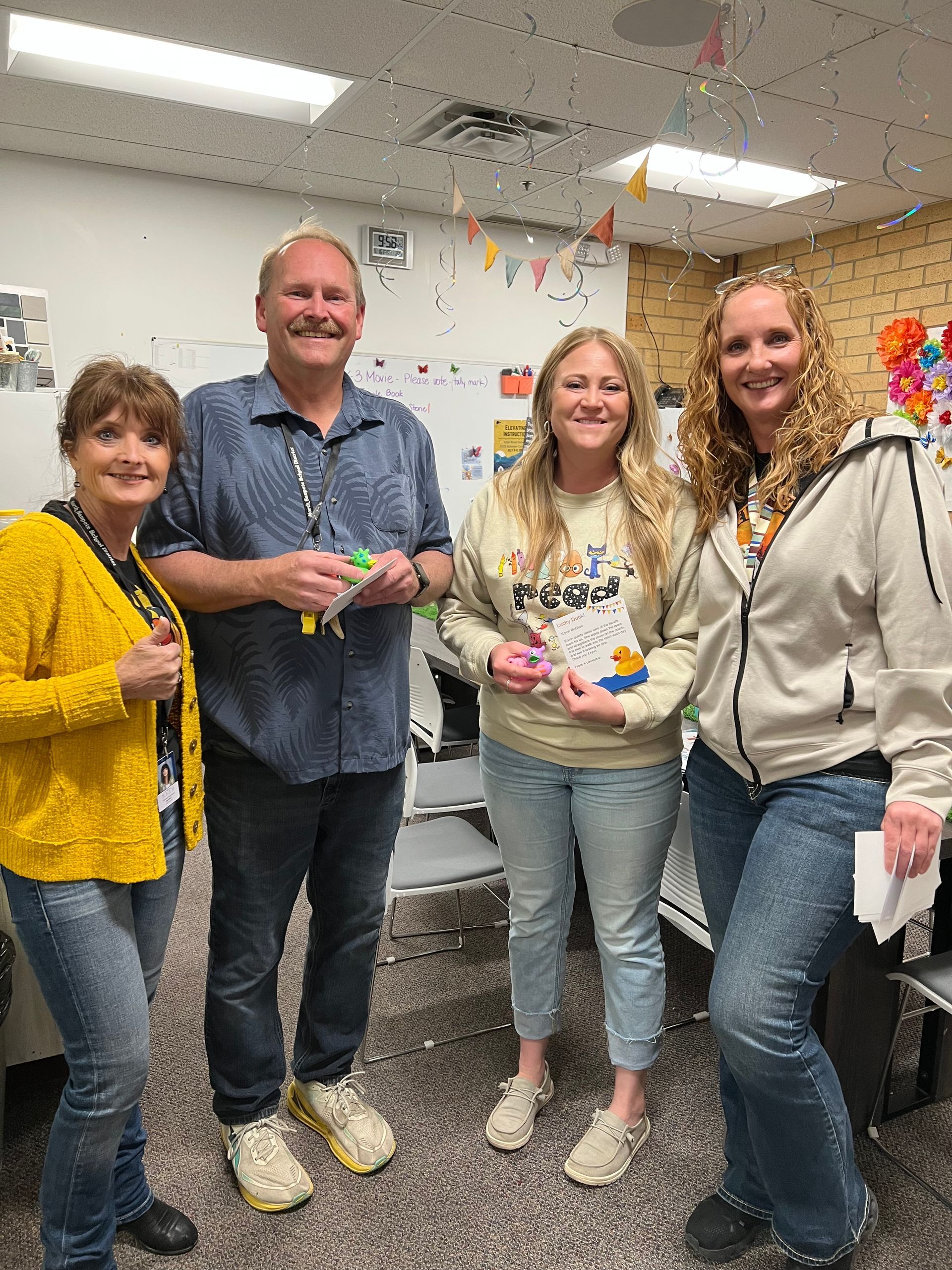 A group of people are standing next to each other in a room.