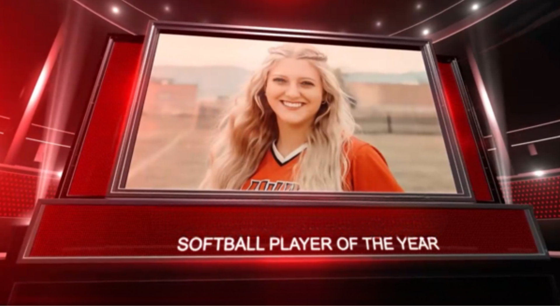Smiling softball player in orange jersey framed on a red awards graphic labeled “Softball Player of the Year”