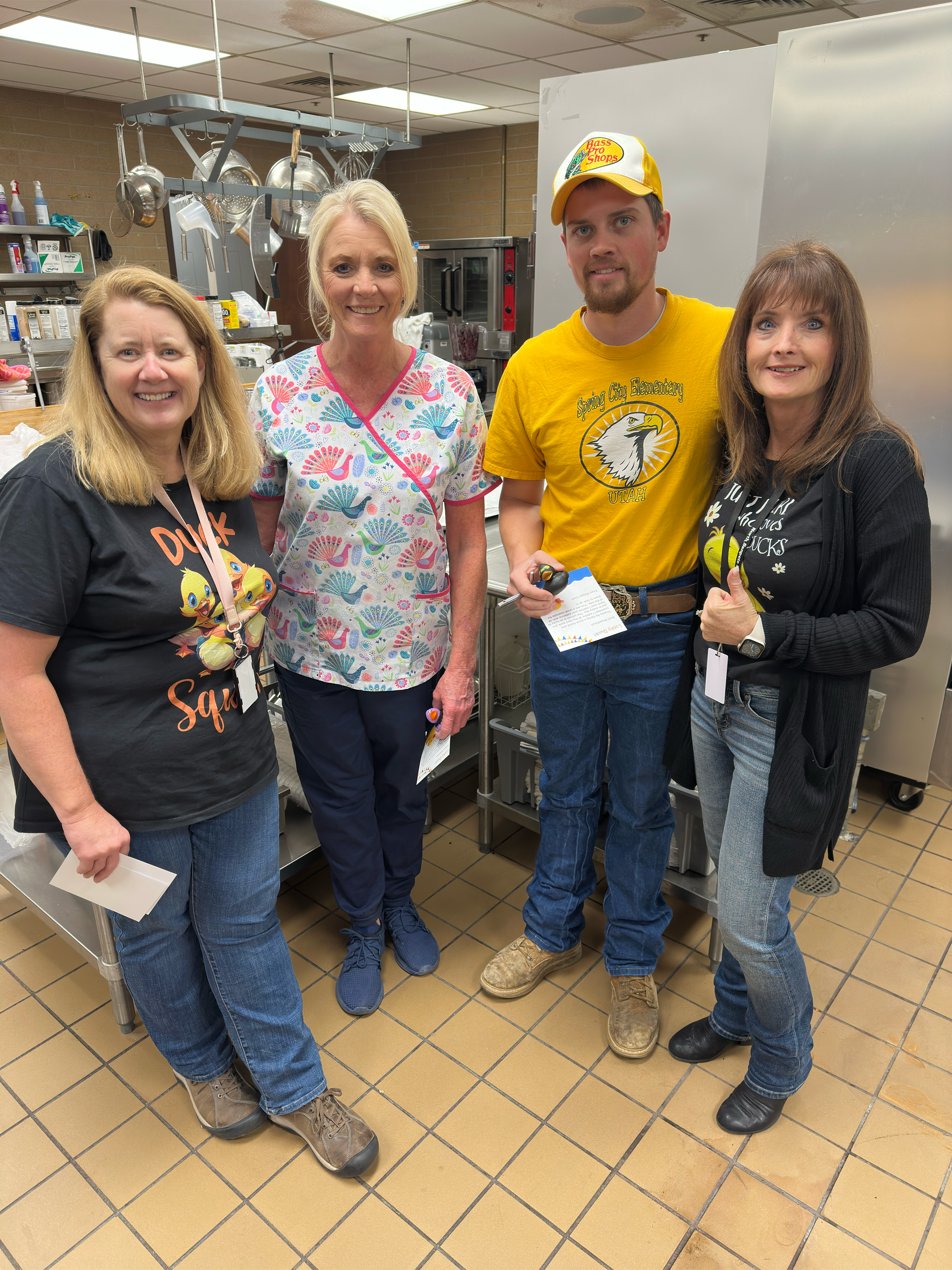 A group of people are posing for a picture in a kitchen.