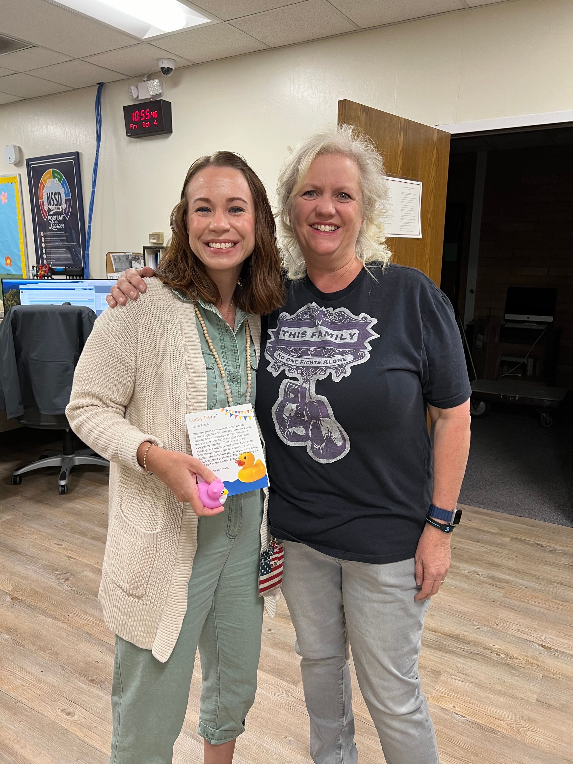 Two women are standing next to each other in a room.