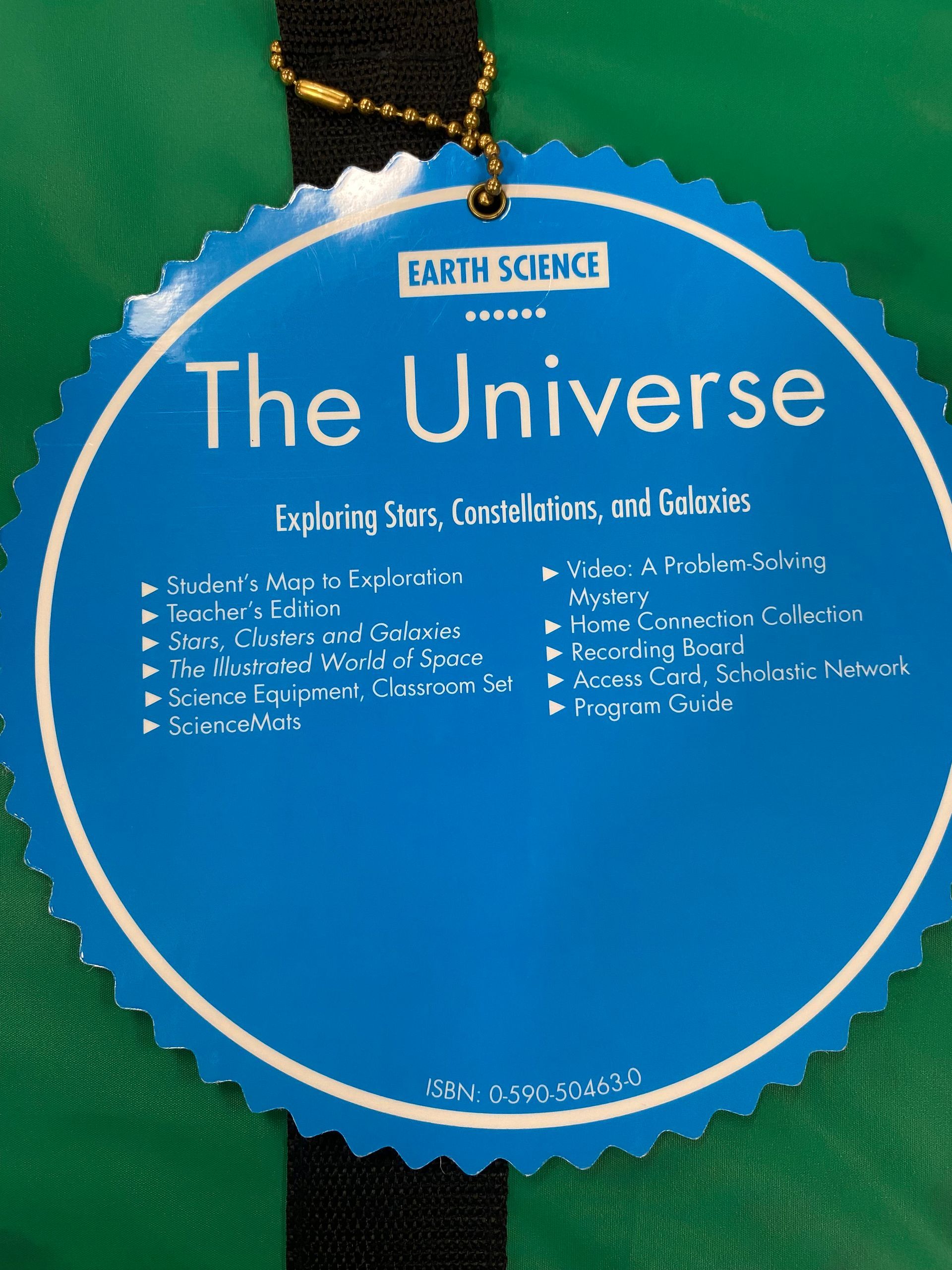 Blue scalloped science display titled “The Universe” with a list of cosmic topics on a green background