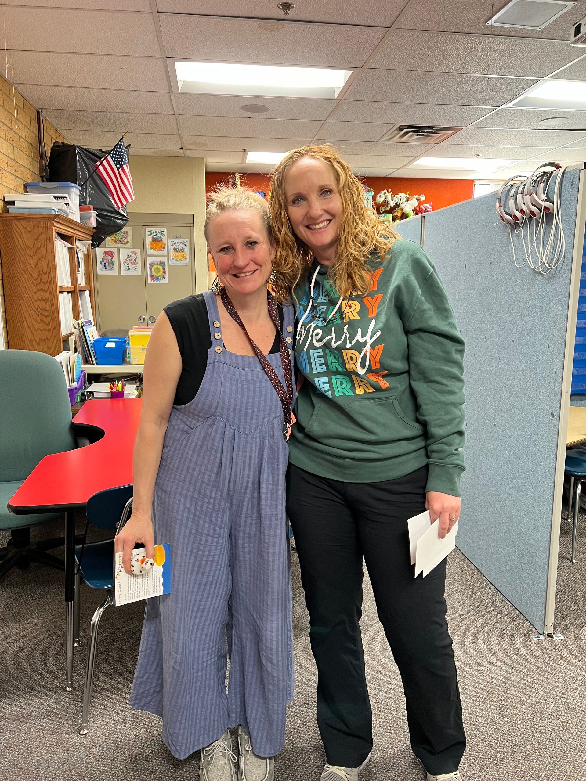 Two women are standing next to each other in a room.