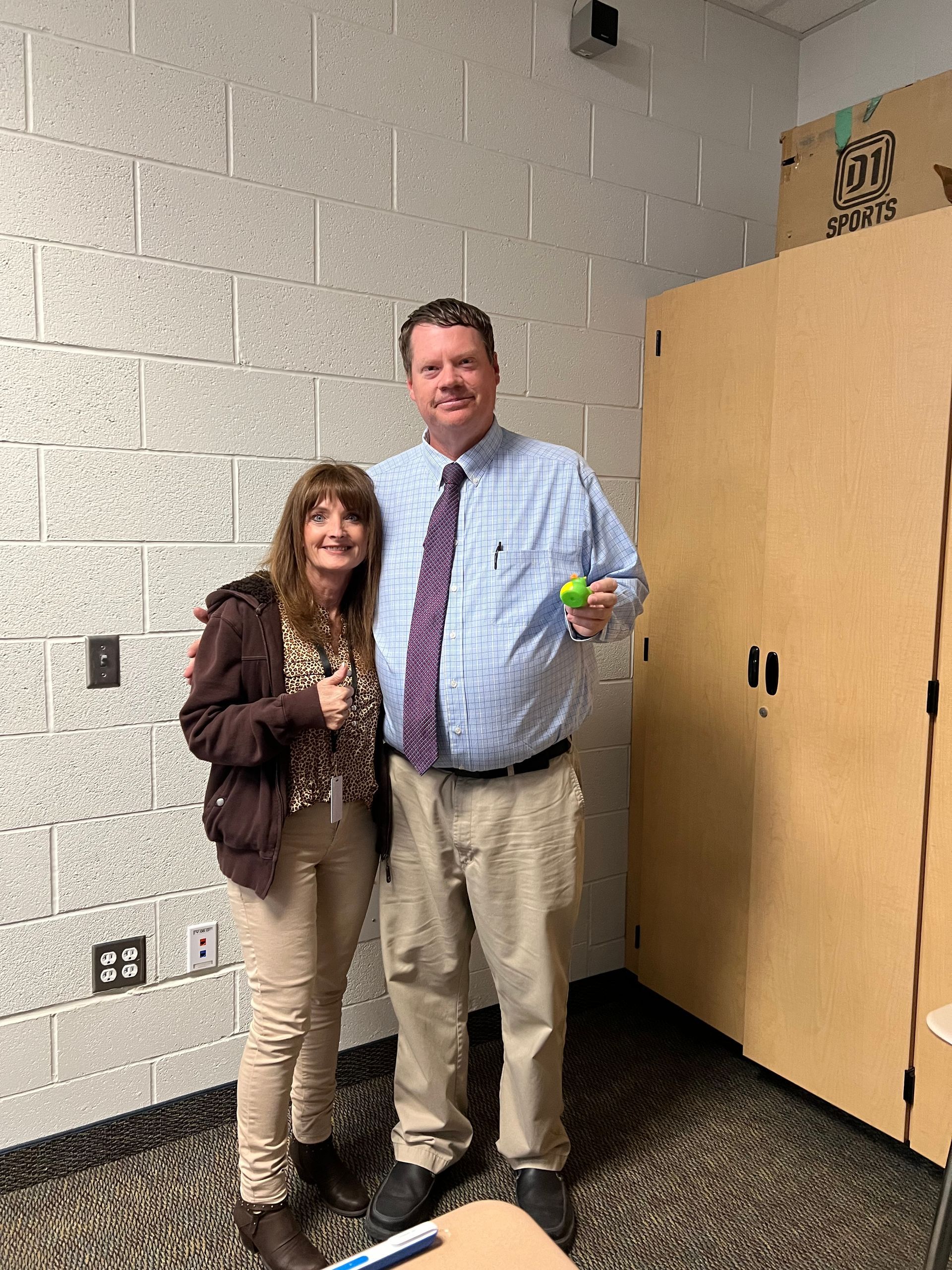 A man and a woman are standing next to each other in a room.