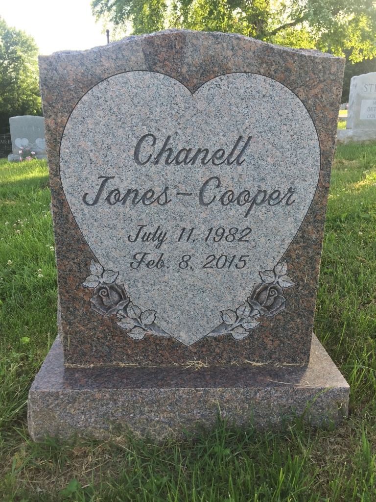 Headstone of Chanell Jones-Cooper, with heart-shaped inscription, dates: July 11, 1982 - Feb. 5, 2015, in a cemetery.