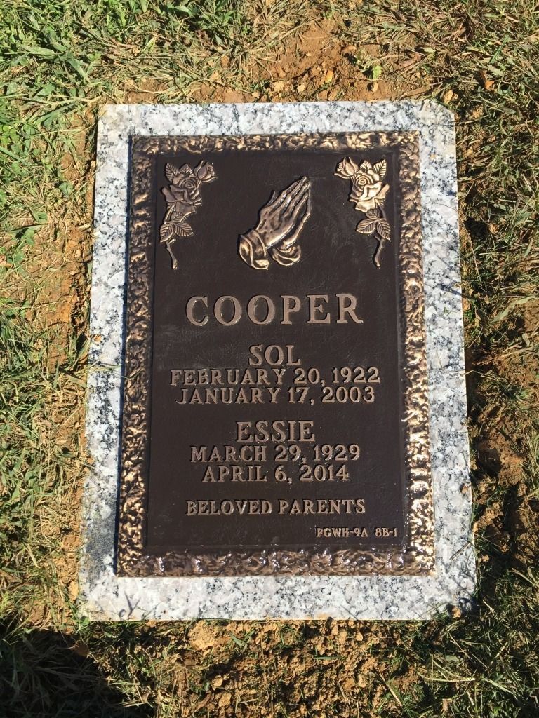 Headstone for Sol and Essie Cooper, with dates of birth and death, and praying hands.