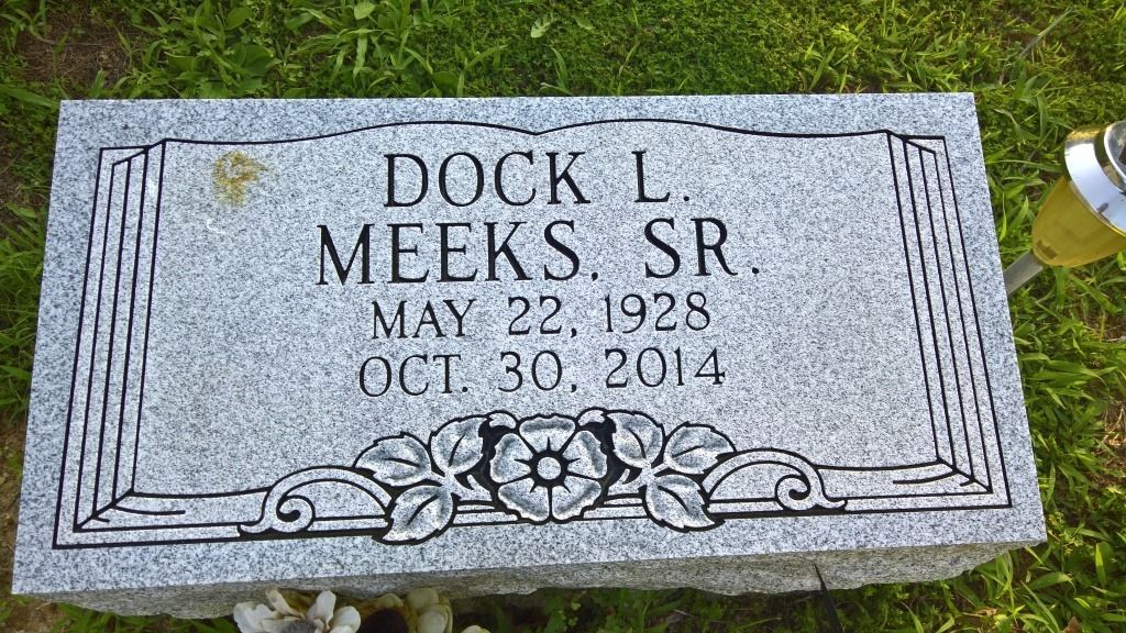 Headstone of Dock L. Meeks Sr., born May 22, 1928, died October 30, 2014, with floral and decorative borders.