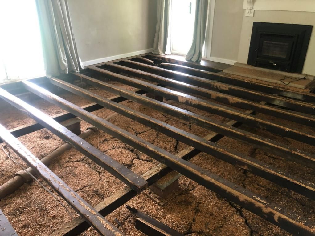 A Living Room With a Wooden Floor Demolished — TC Pest & Termite Control In Bowral, NSW
