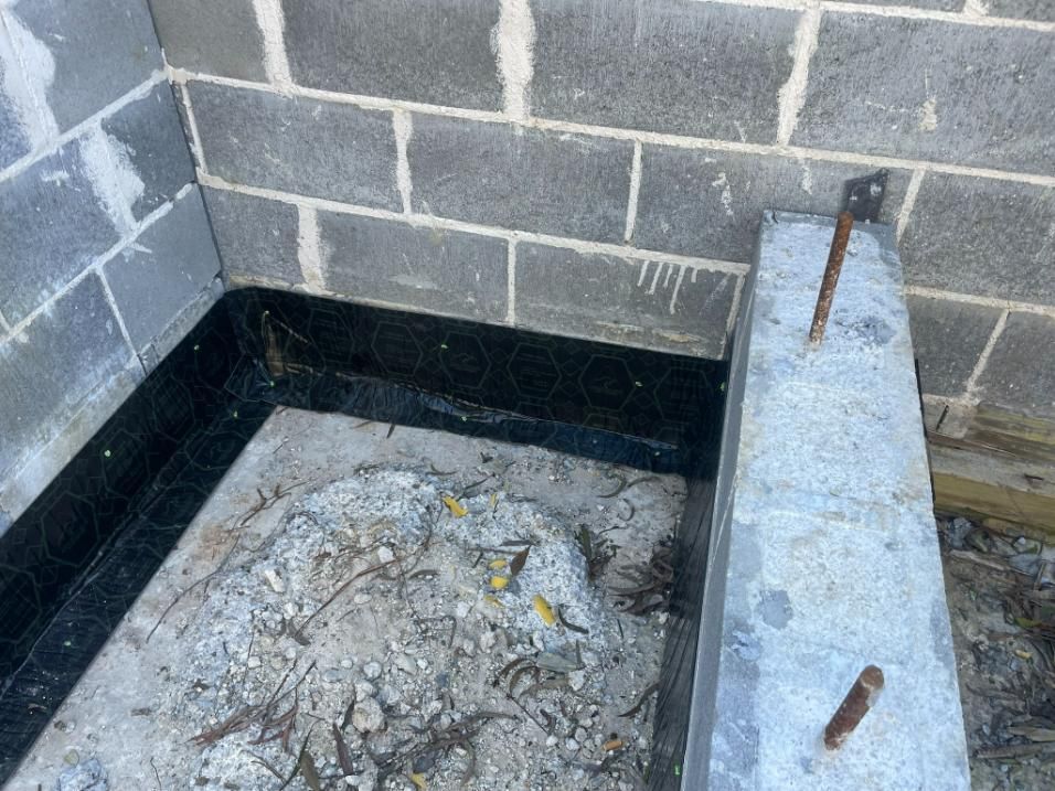 A Concrete Block is Sitting Next to a Brick Wall — TC Pest & Termite Control In Moss Vale, NSW