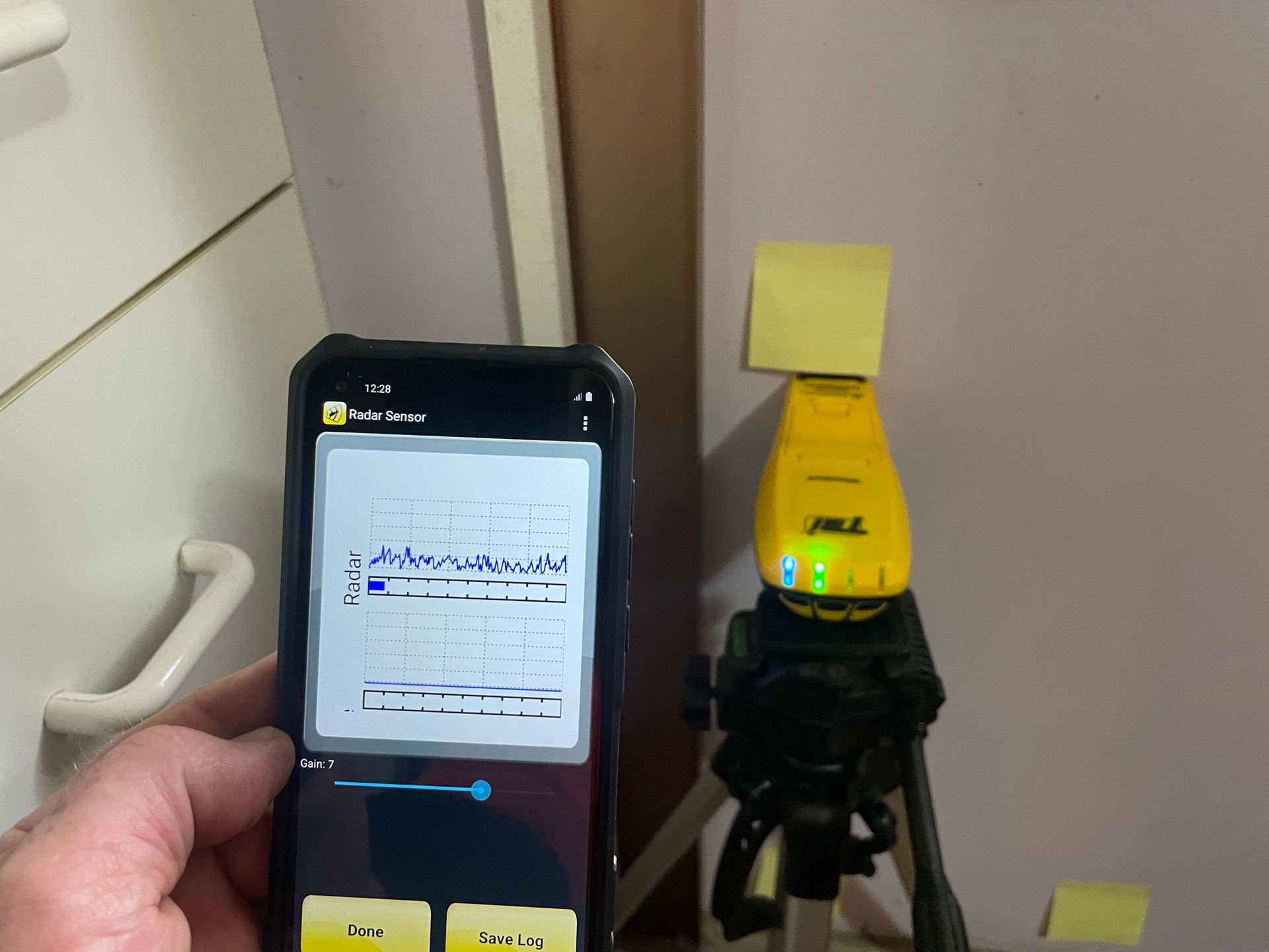 A Person is Holding a Pest Control Device — TC Pest & Termite Control In Bowral, NSW