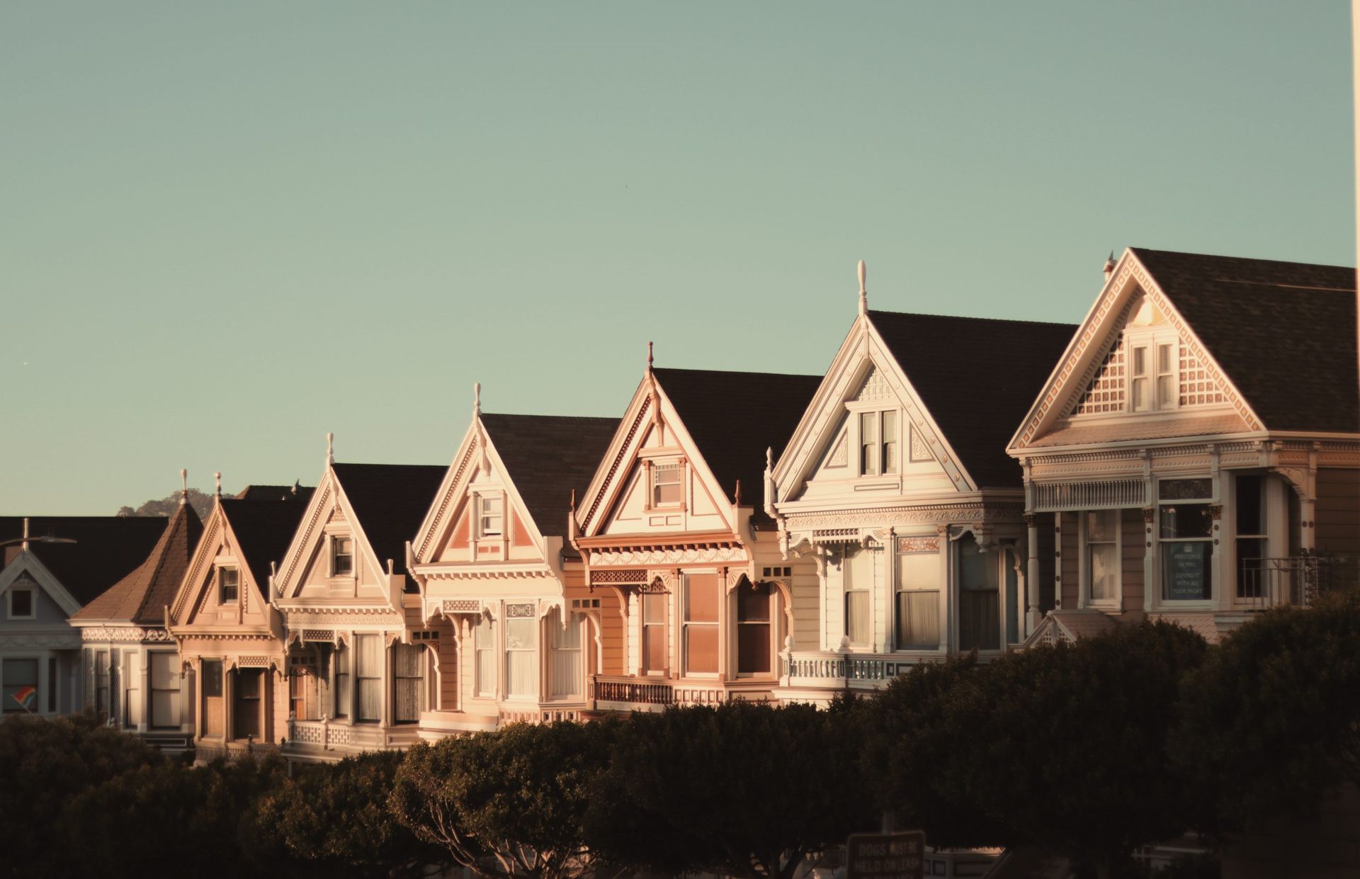 A row of houses with a blue sky in the background