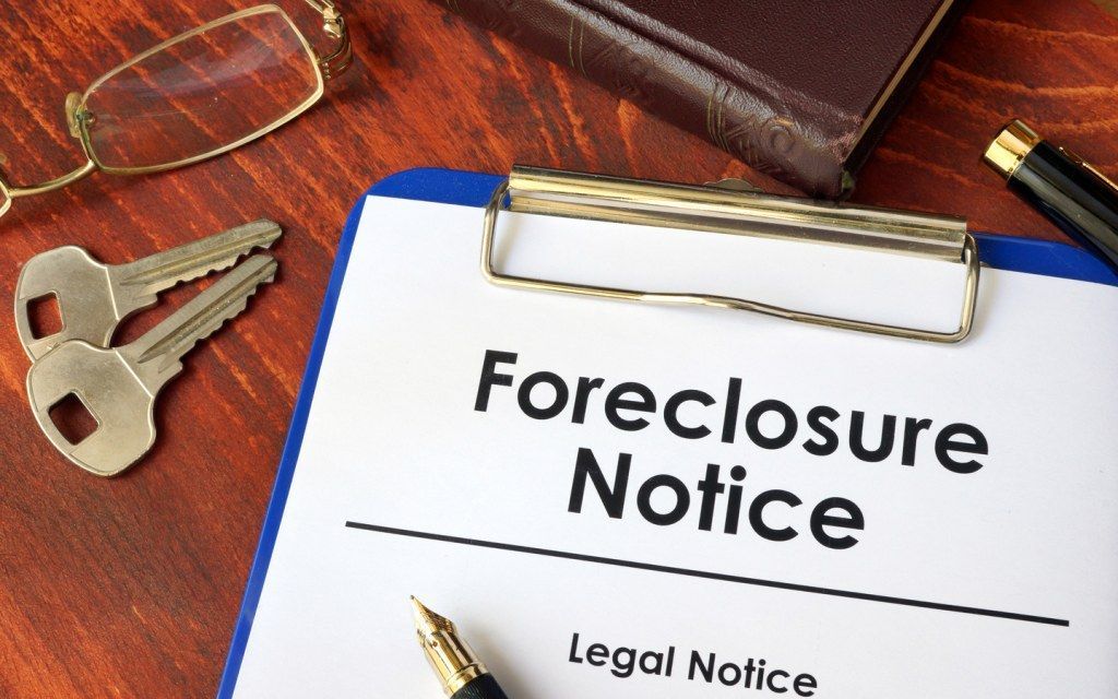 A clipboard with a foreclosure notice on it