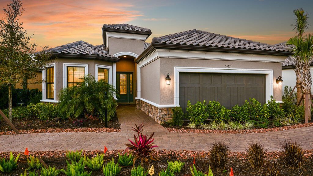 A large house with a garage and a driveway in front of it.