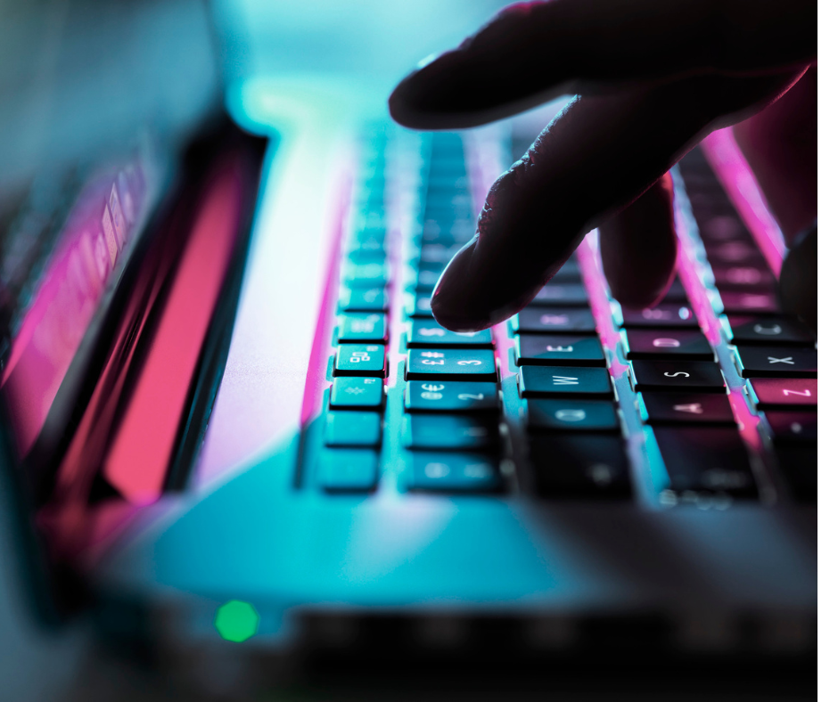 A close up of a person typing on a laptop keyboard