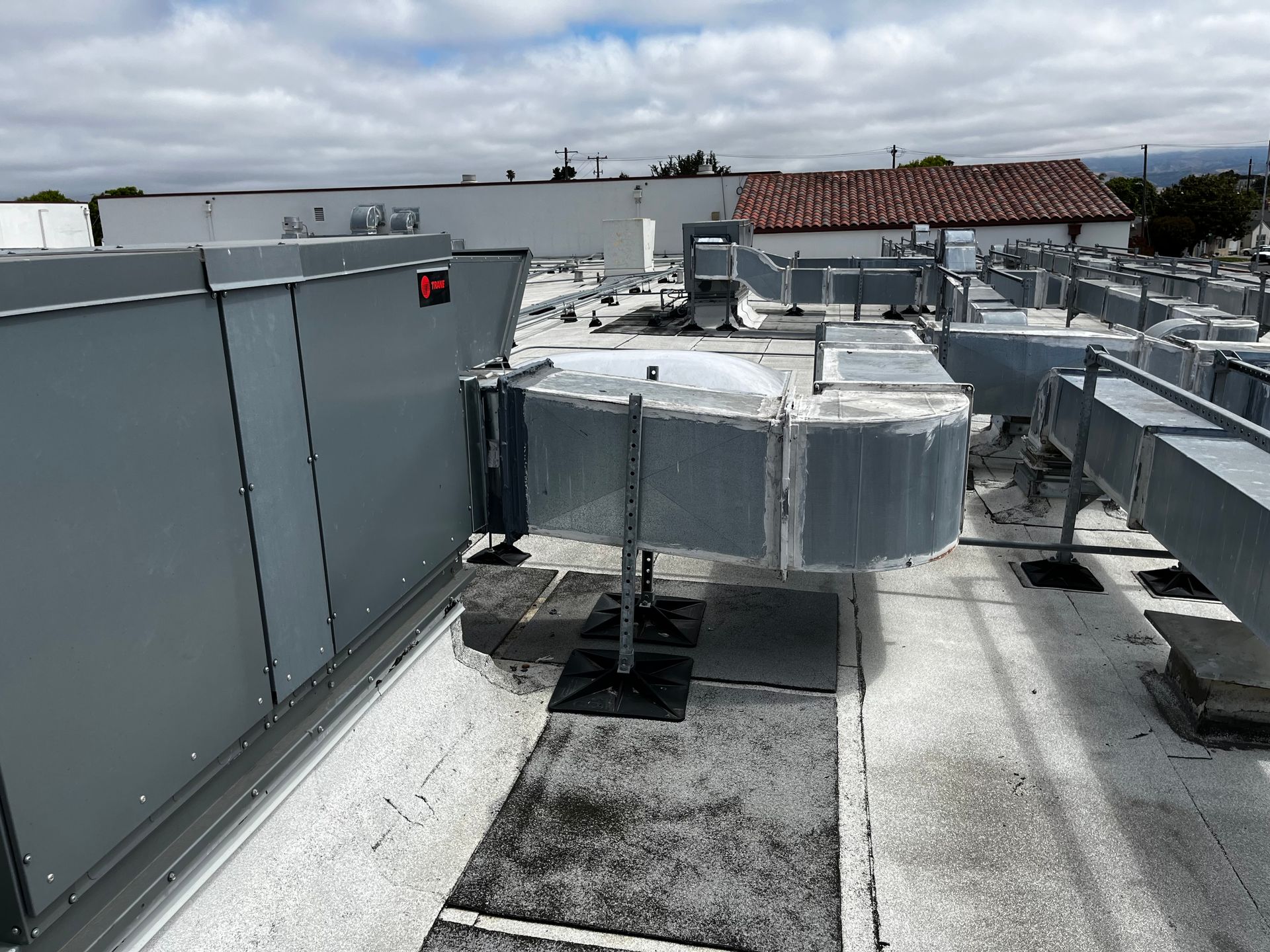 The roof of a building with a lot of pipes on it