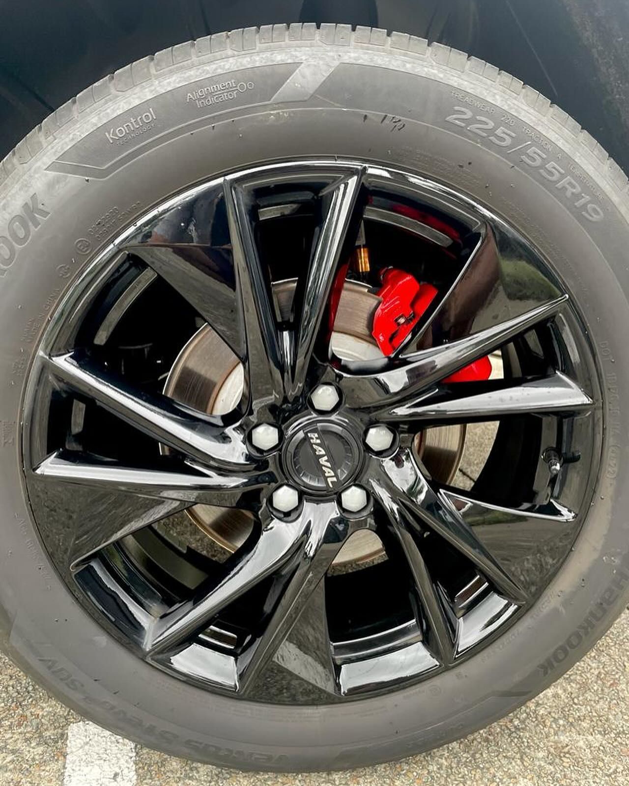 Black car wheel with a red brake caliper, tire size 225/55R19. — Coolum Smash Repairs in Coolum Beach, QLD