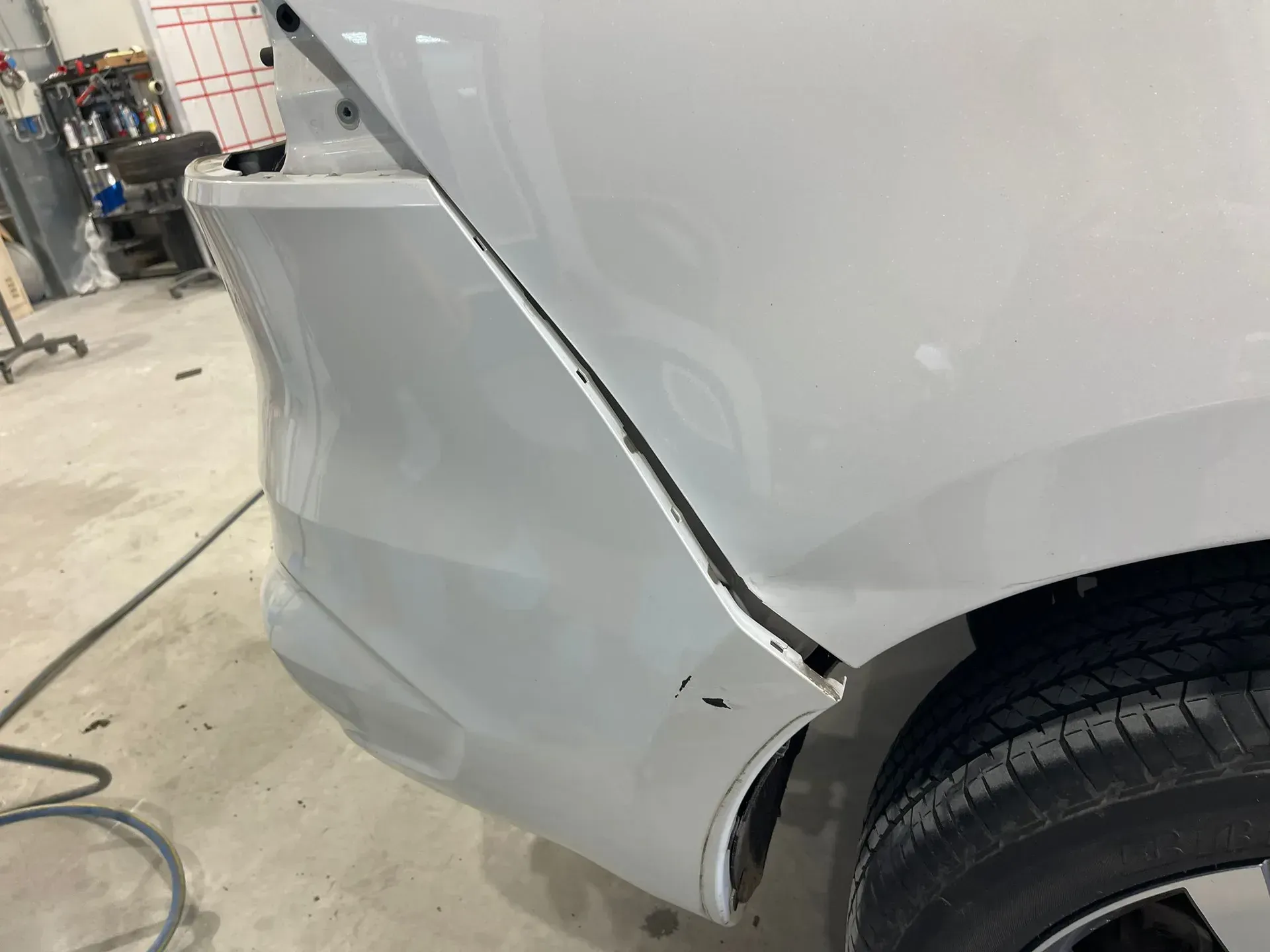Damaged white car panel with a large vertical split. — Coolum Smash Repairs in Coolum Beach, QLD