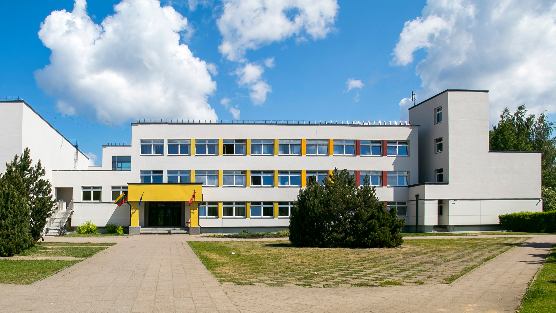 A large white building with a yellow entrance