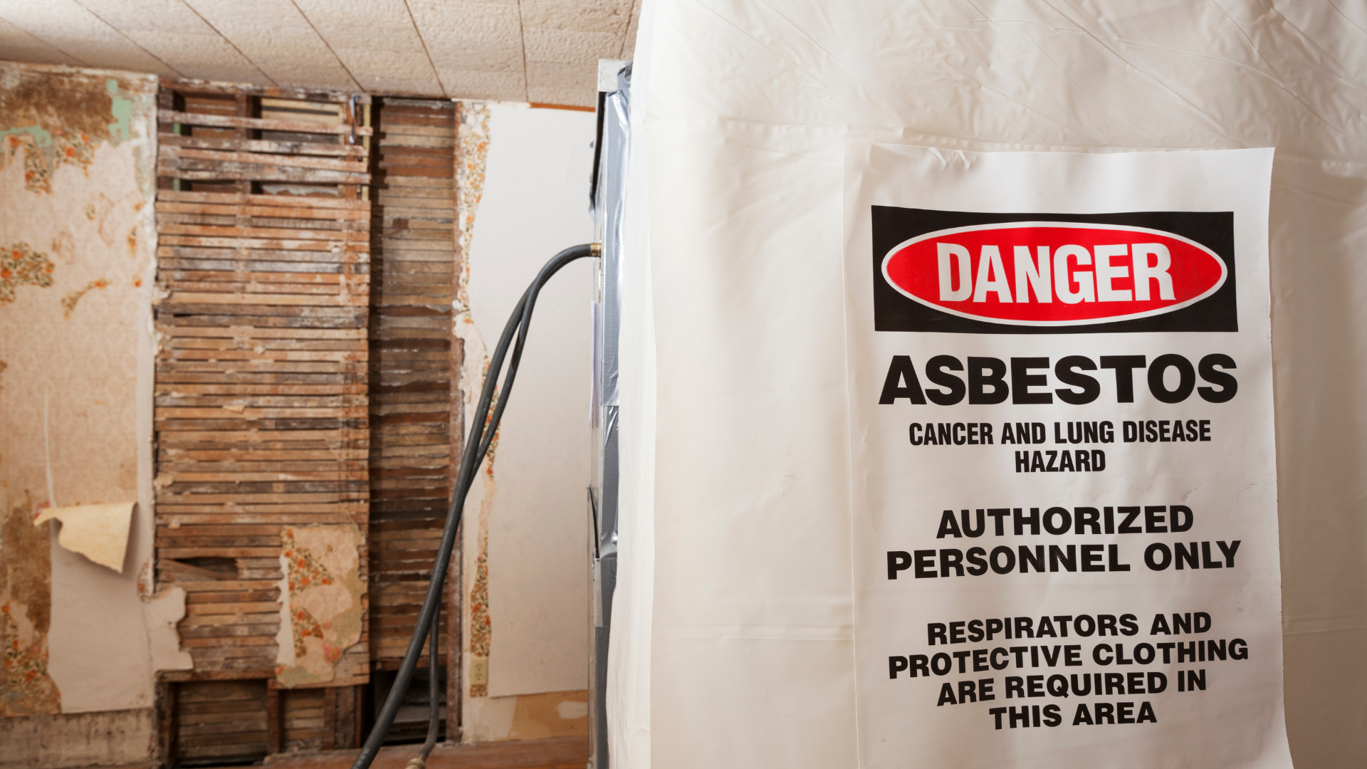 A bag of asbestos is sitting in a room next to a wooden wall.