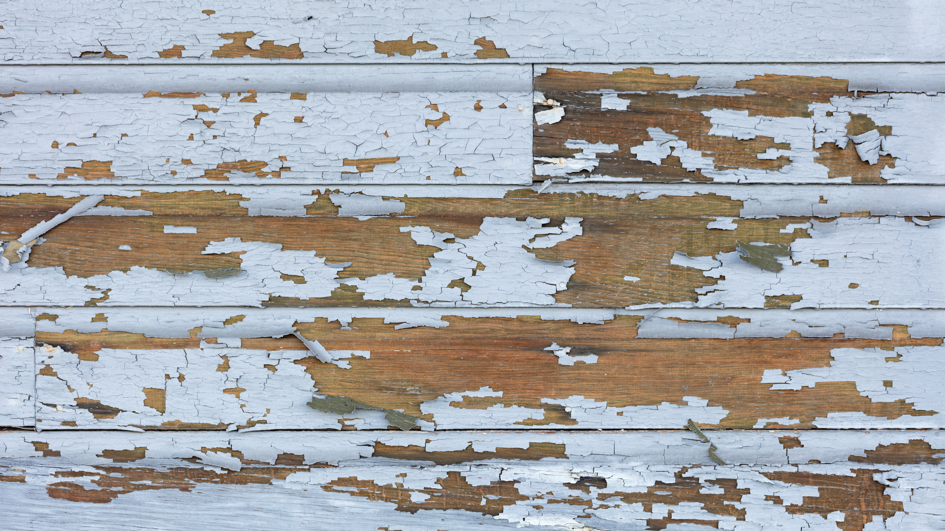 A close up of a wooden surface with peeling paint