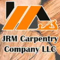 Logo for JRM Carpentry Company LLC, featuring an orange house shape, a wood plane, and the company name.