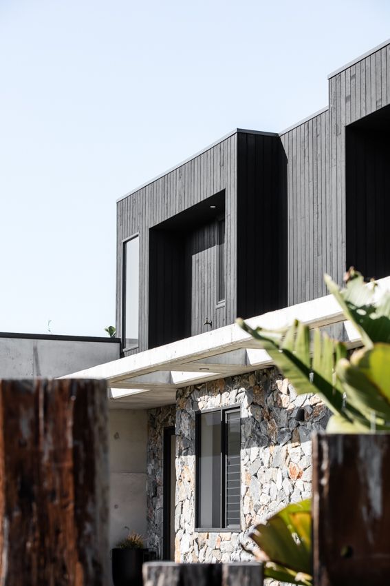 Modern house with black wood siding and stone facade — Make The Mark Building Services in Illawarra, NSW