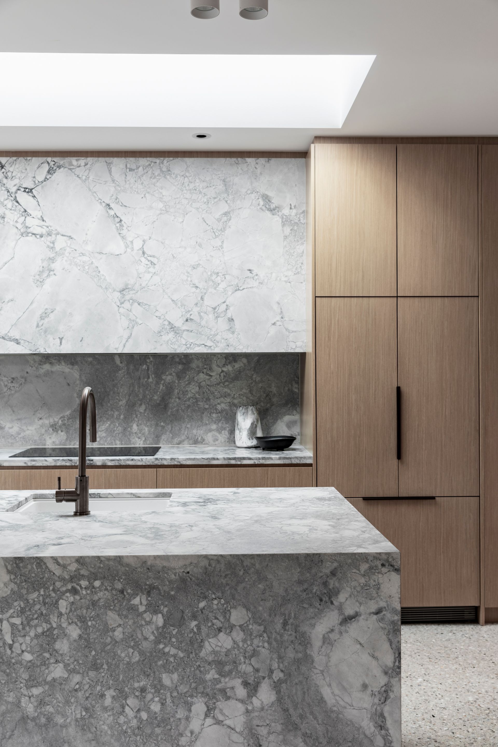 Modern kitchen with marble countertops, wooden cabinets, and a skylight — Make The Mark Building Services in Illawarra, NSW