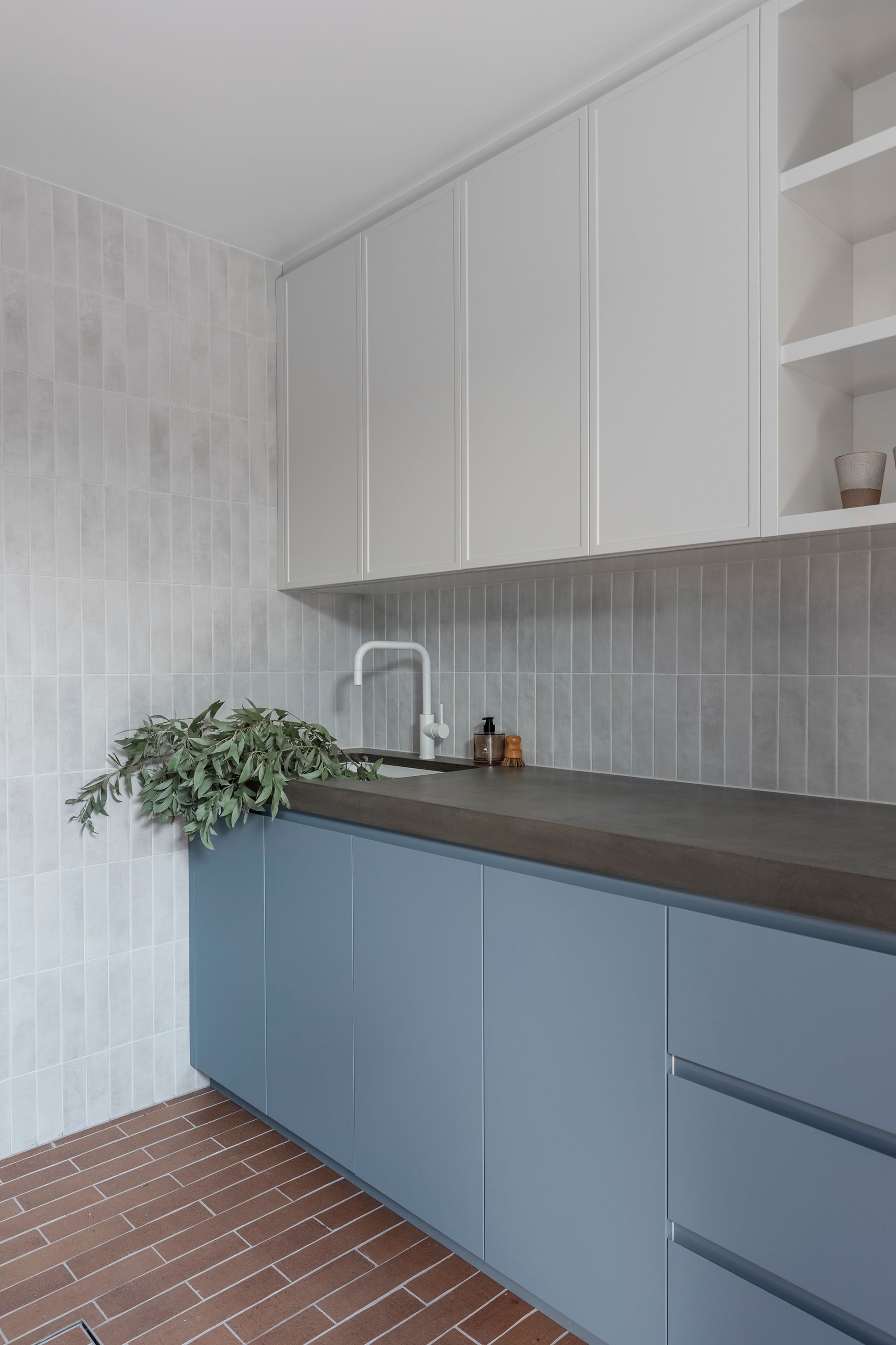 Blue and white kitchen cabinetry with backsplash and sink; brick flooring — Make The Mark Building Services in Illawarra, NSW