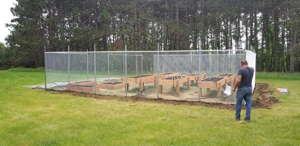 Chain Link Fencing — Man Outside Chain Link Fence in Deerwood, MN