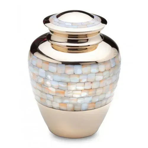 Decorative gold and pearl mosaic urn vase with a white lid on a plain background