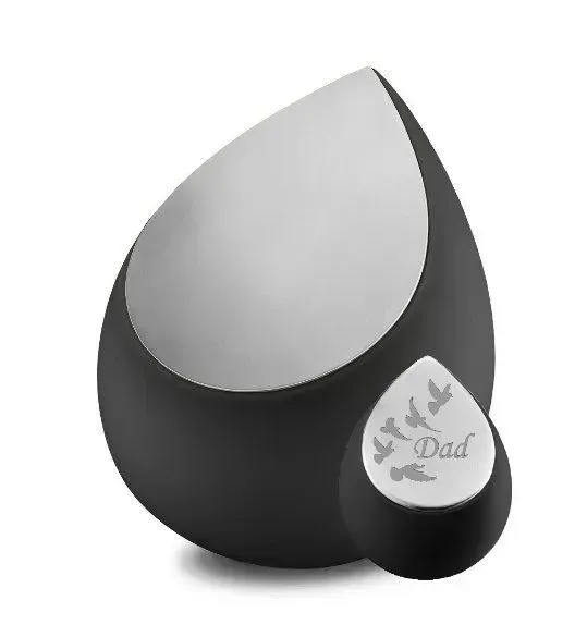 Black teardrop urn with silver top and small matching keepsake urn labeled “Dad”